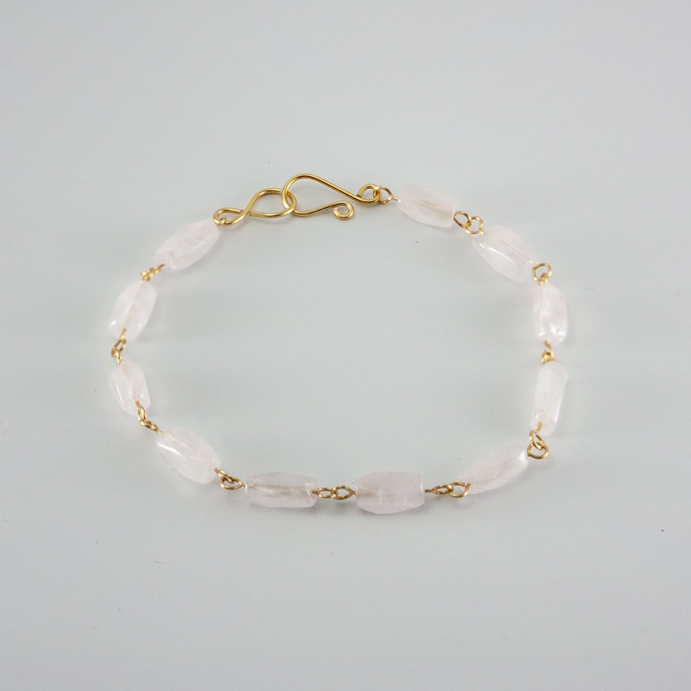 Elegant Rose Quartz Rectangular Gold Link Bracelet featuring soft pink gemstones and silver-plated copper links.