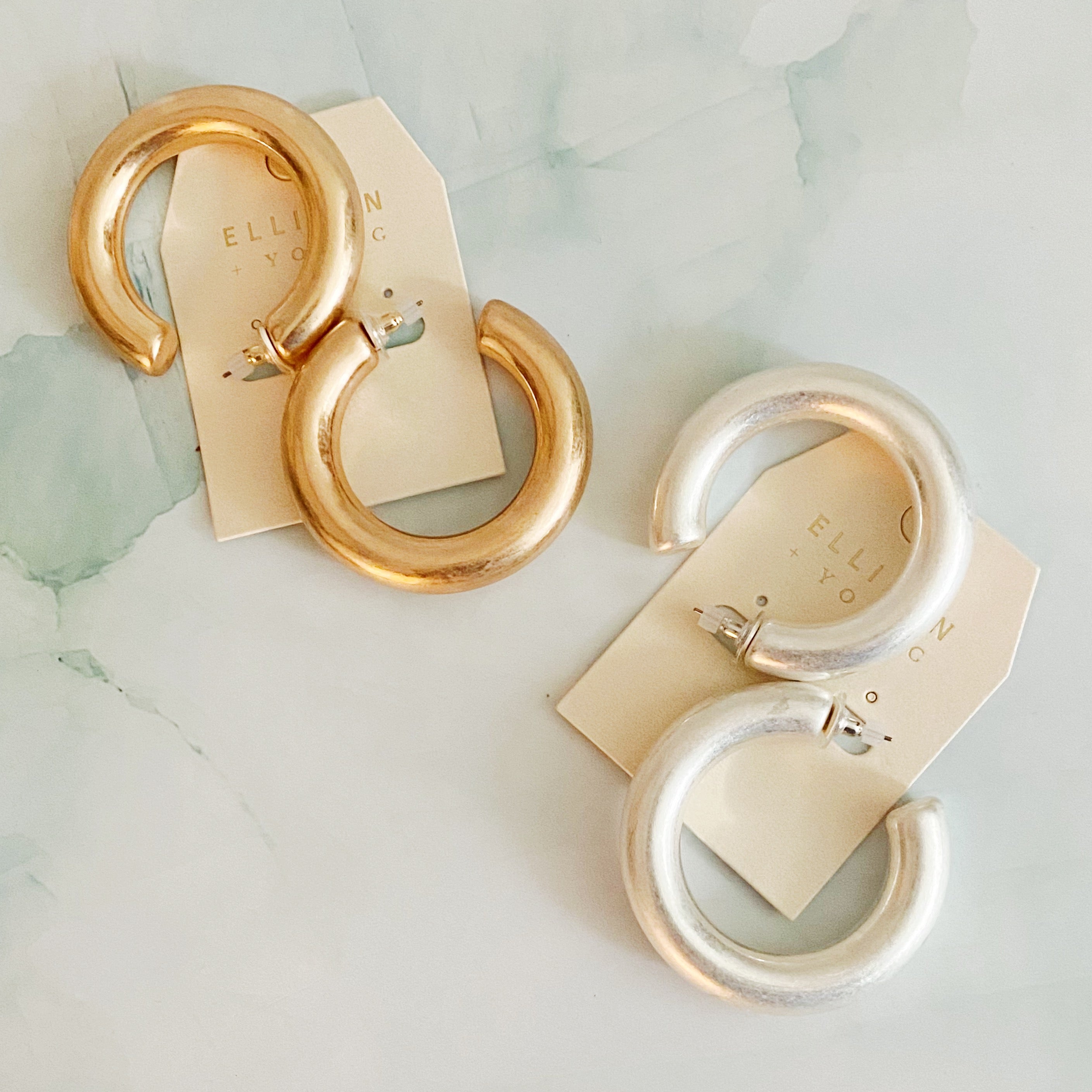 A pair of large round hoop earrings made of alloy metal, showcasing a smooth and shiny finish, perfect for modern and classic styles.