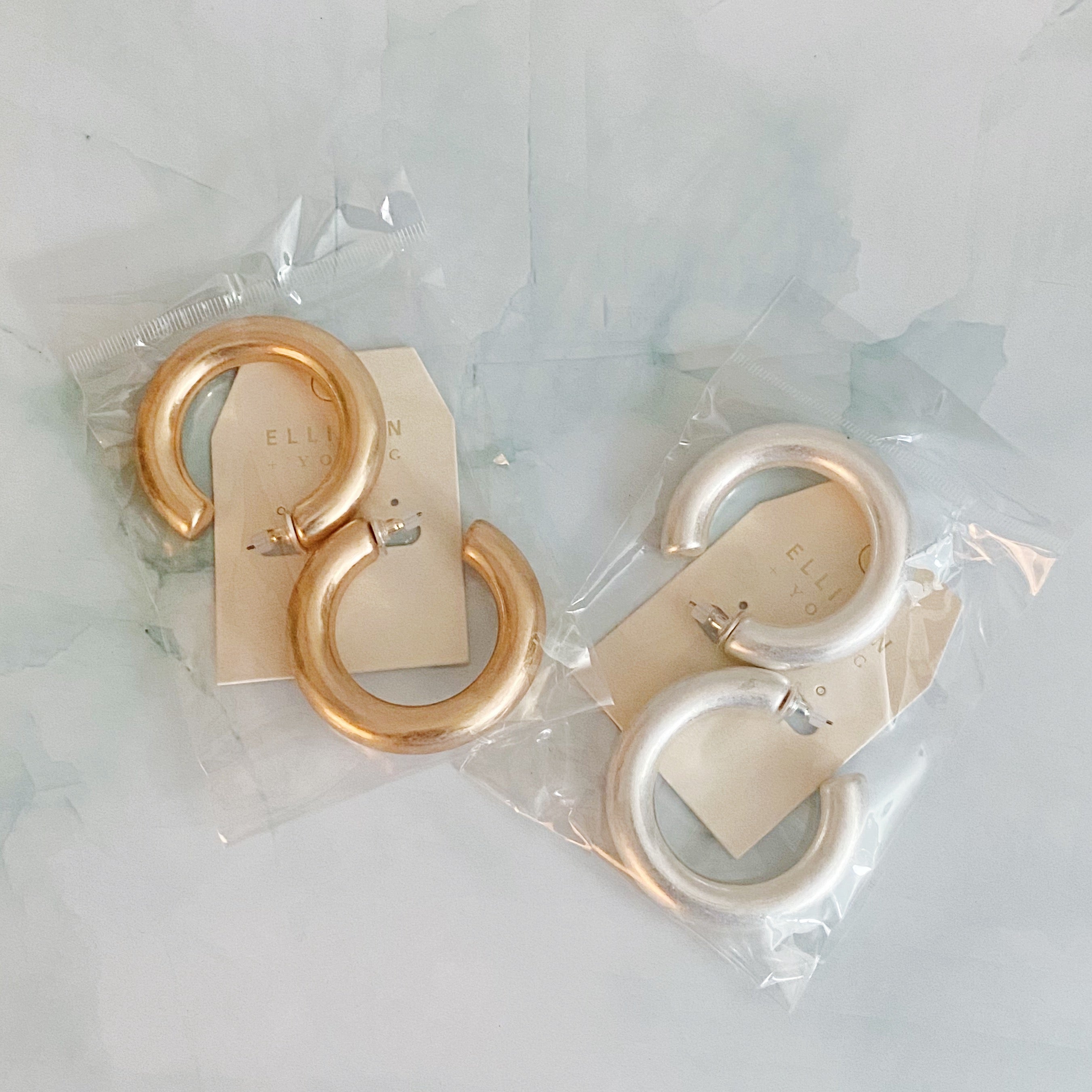 A pair of large round hoop earrings made of alloy metal, showcasing a smooth and shiny finish, perfect for modern and classic styles.