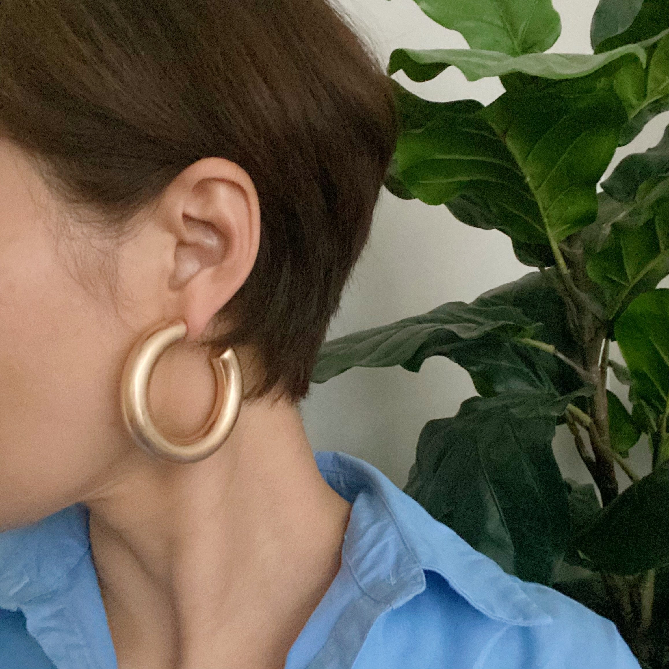 A pair of large round hoop earrings made of alloy metal, showcasing a smooth and shiny finish, perfect for modern and classic styles.