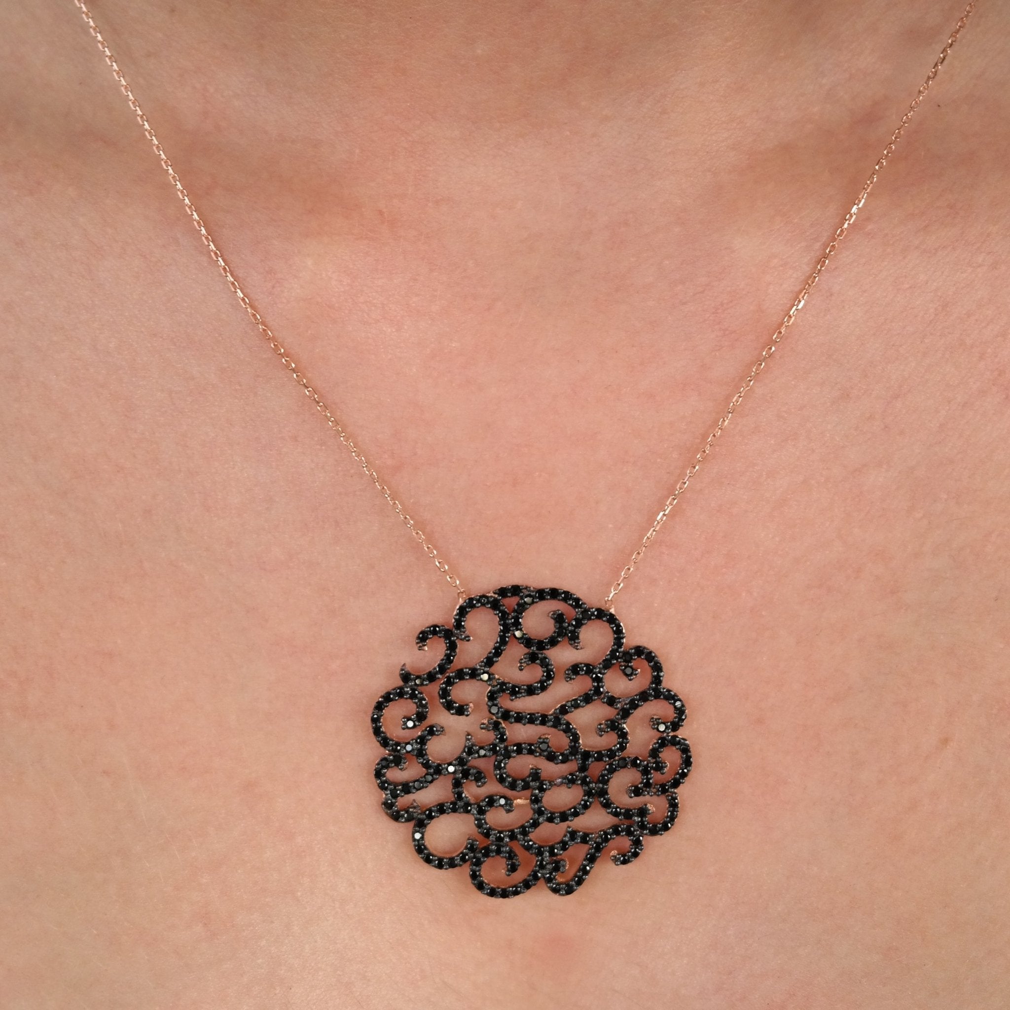 Round Black Ivy Silver Necklace featuring a CZ crystal pendant and 18K rose gold accents, elegantly displayed on a soft background.