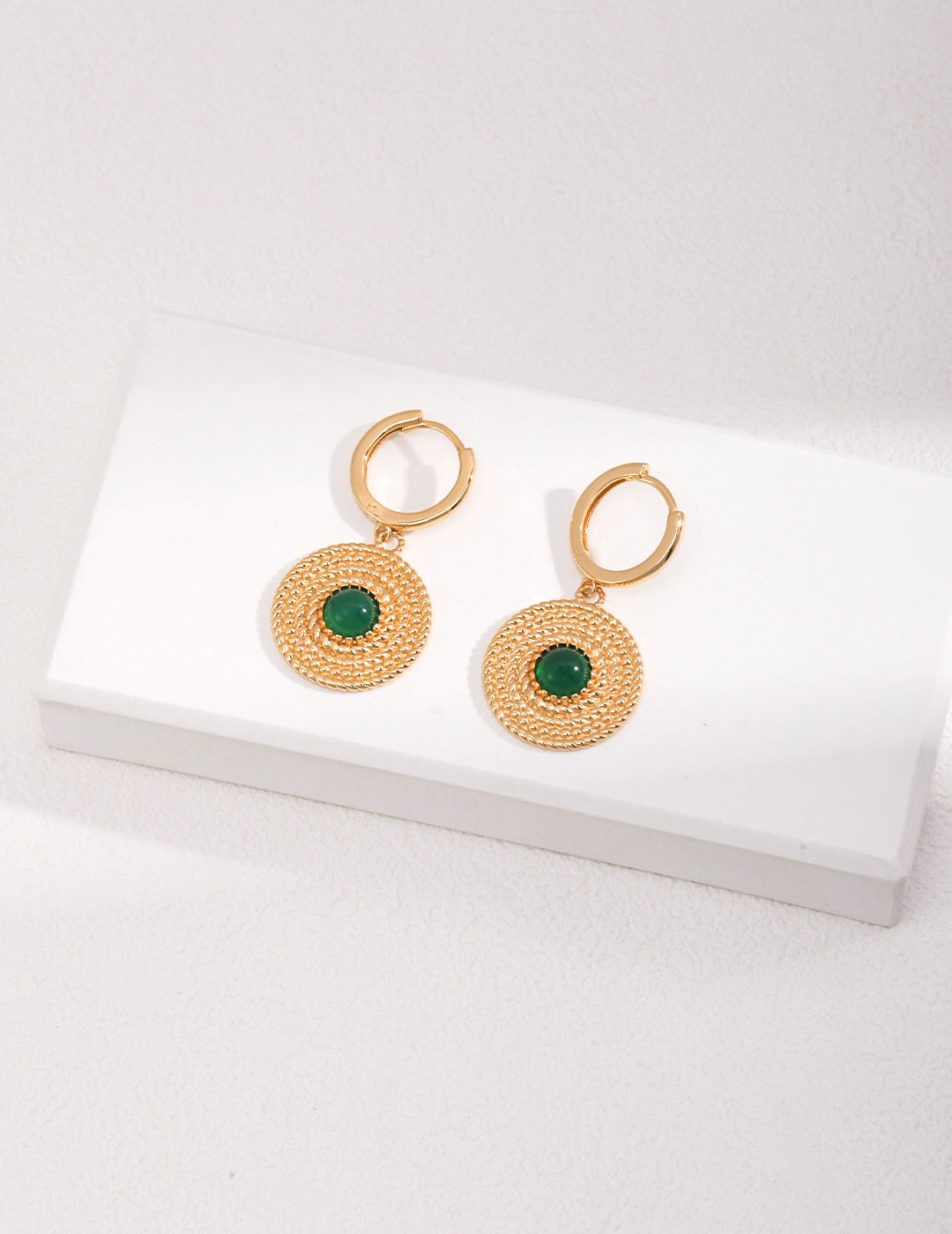 A pair of handmade Round Green Pith Earrings featuring gold vermeil accents, showcasing their unique design and vibrant color.