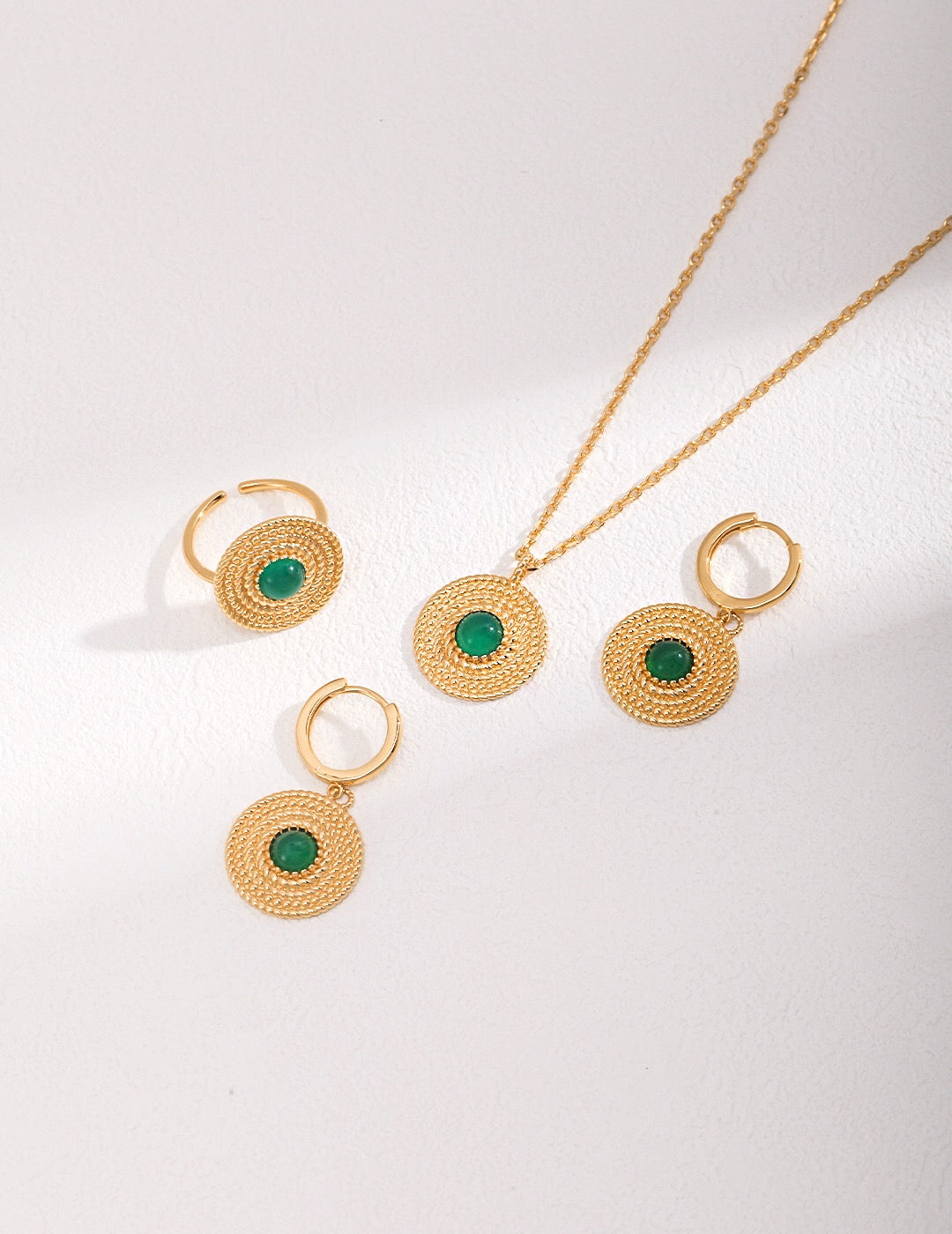 A pair of handmade Round Green Pith Earrings featuring gold vermeil accents, showcasing their unique design and vibrant color.