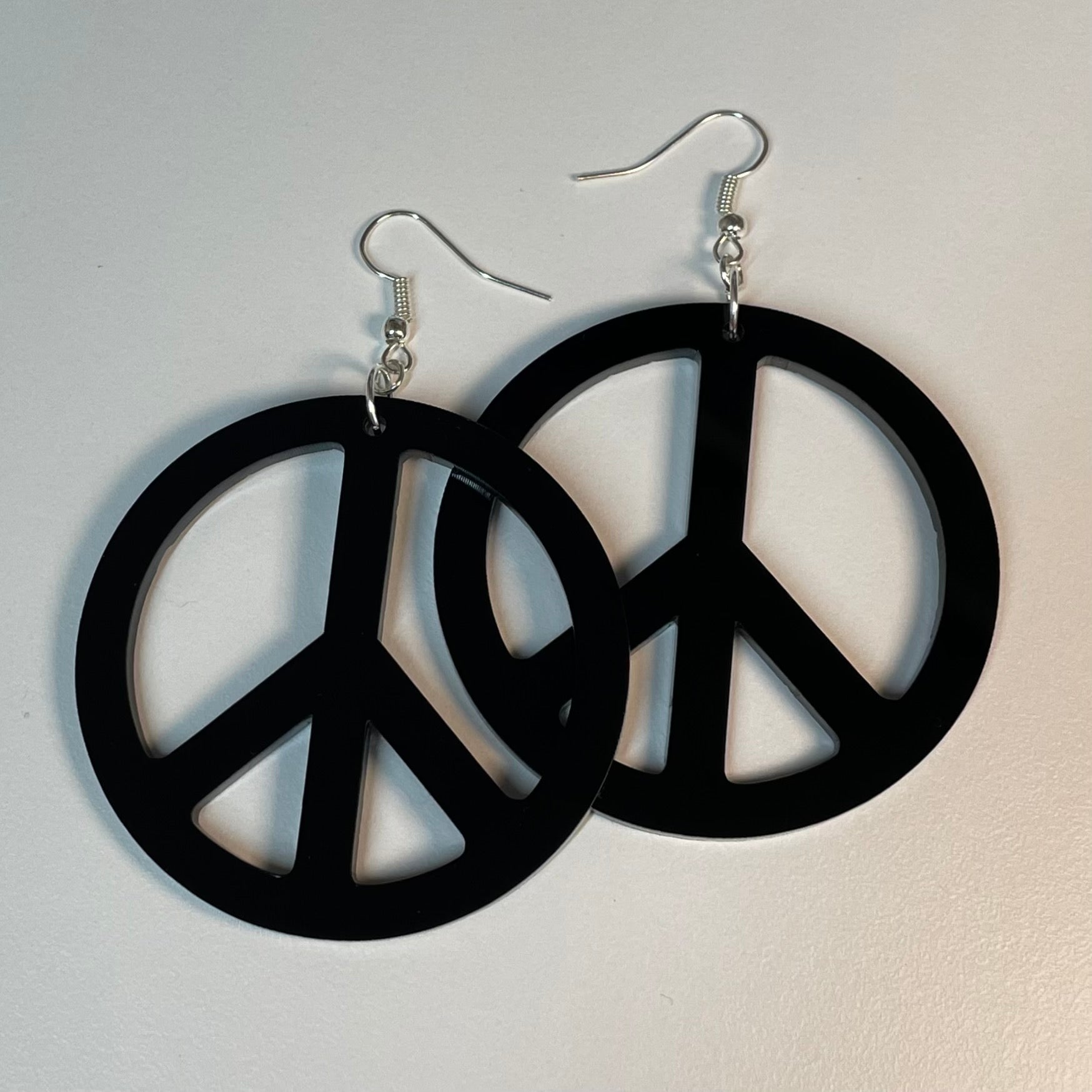 A pair of stylish Round Peace Earrings made from laser-cut acrylic, featuring a peace symbol design in customizable colors.