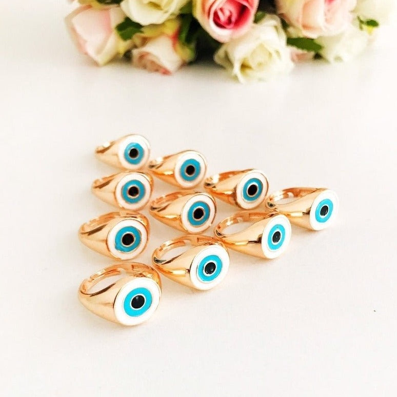 Round Turquoise Evil Eye Ring featuring a white evil eye bead and rose gold accents, adjustable design for all sizes.