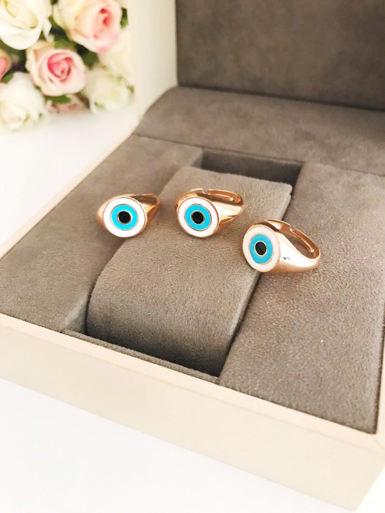 Round Turquoise Evil Eye Ring featuring a white evil eye bead and rose gold accents, adjustable design for all sizes.