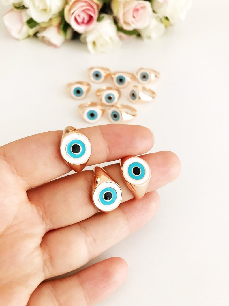 Round Turquoise Evil Eye Ring featuring a white evil eye bead and rose gold accents, adjustable design for all sizes.