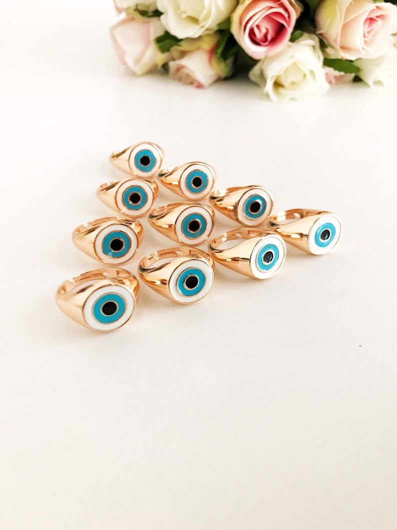 Round Turquoise Evil Eye Ring featuring a white evil eye bead and rose gold accents, adjustable design for all sizes.