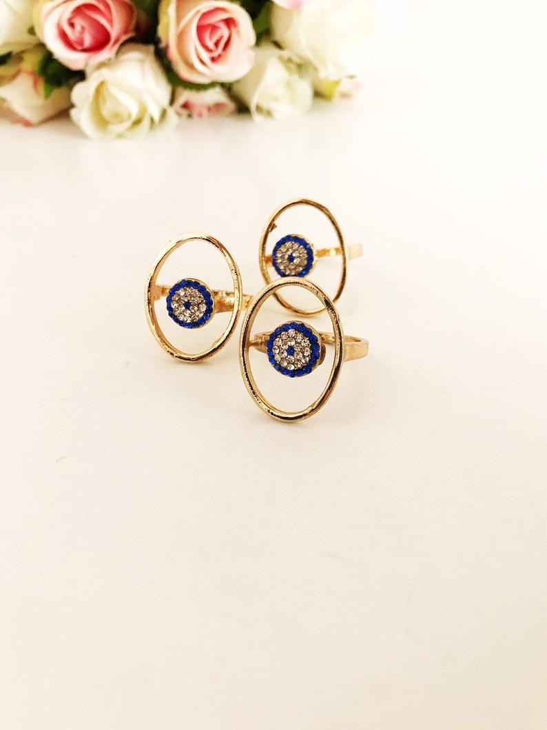 Round Zirconia Evil Eye Beads featuring a gold oval frame and blue evil eye bead, symbolizing protection and elegance.