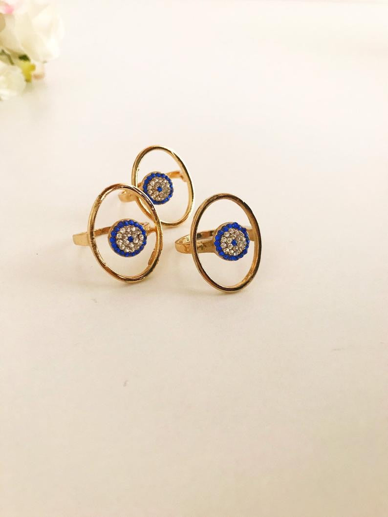 Round Zirconia Evil Eye Beads featuring a gold oval frame and blue evil eye bead, symbolizing protection and elegance.