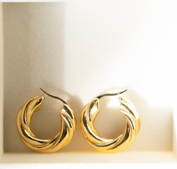 Stylish ROXY Hoops featuring a twisted tubular design in shiny 18k gold plated stainless steel, perfect for any occasion.