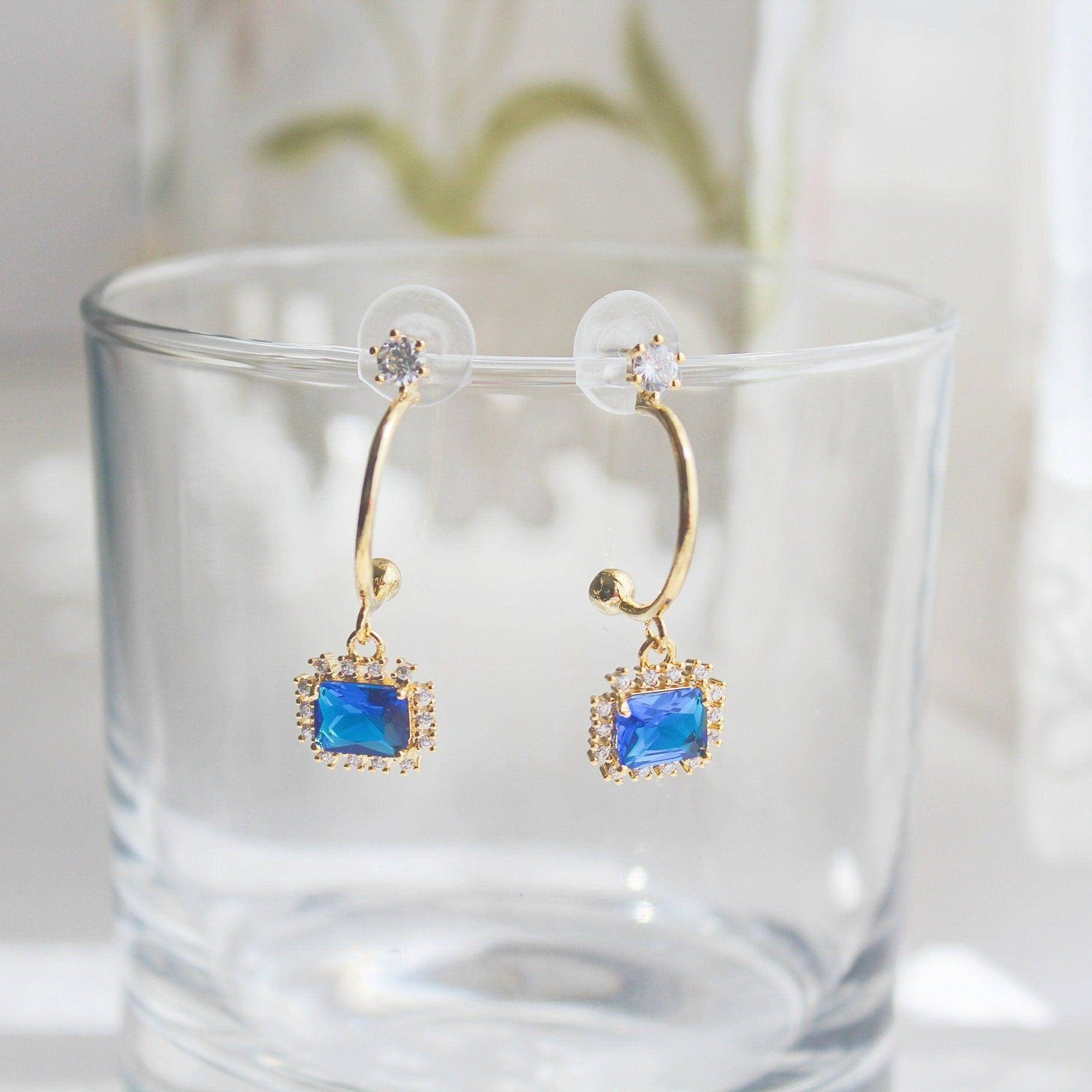 Elegant royal blue square crystal half hoop earrings made with sterling silver and gold plated bronze.