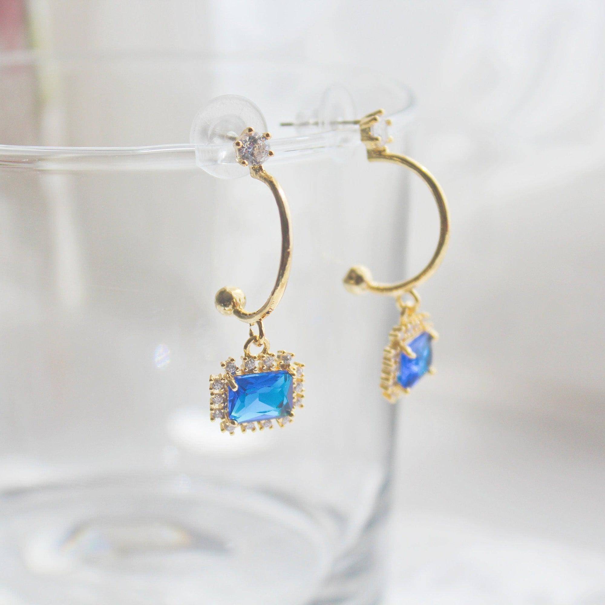 Elegant royal blue square crystal half hoop earrings made with sterling silver and gold plated bronze.