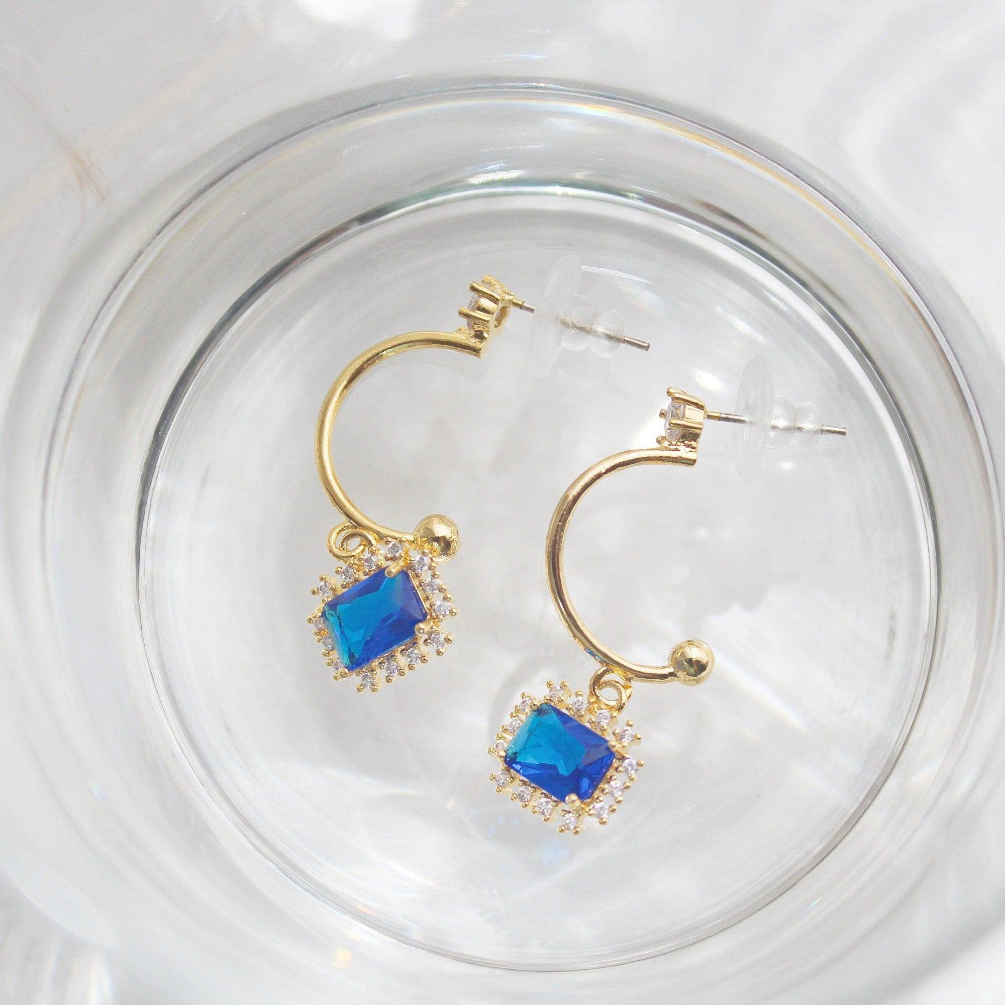 Elegant royal blue square crystal half hoop earrings made with sterling silver and gold plated bronze.