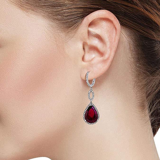 Elegant Ruby Pave Teardrop Infinity Drop earrings embellished with certified crystals, crafted in 18K white gold, showcasing a luxurious design.