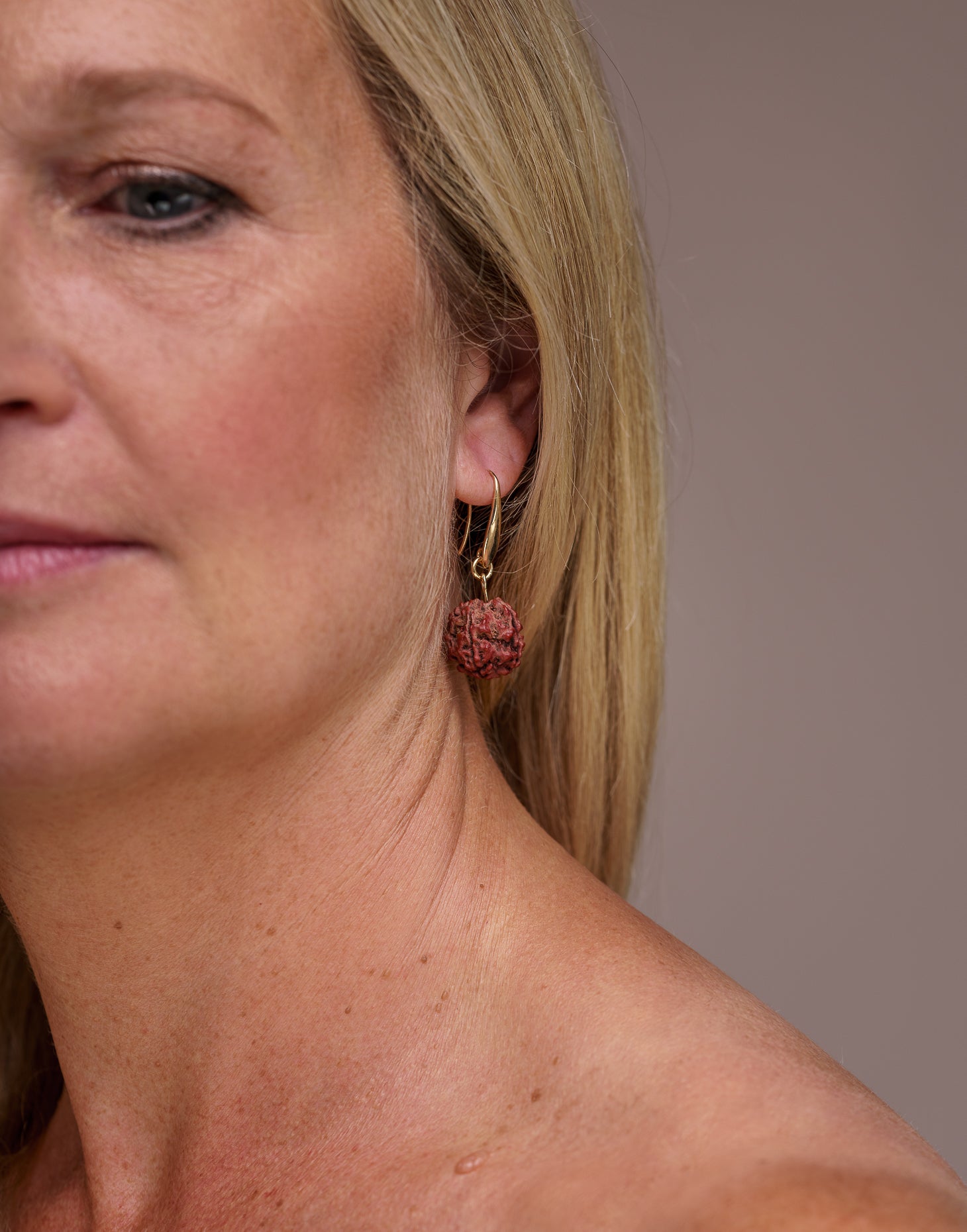 A pair of Rudraksha earrings featuring natural Rudraksha seeds and raw brass hooks, showcasing their unique texture and organic design.