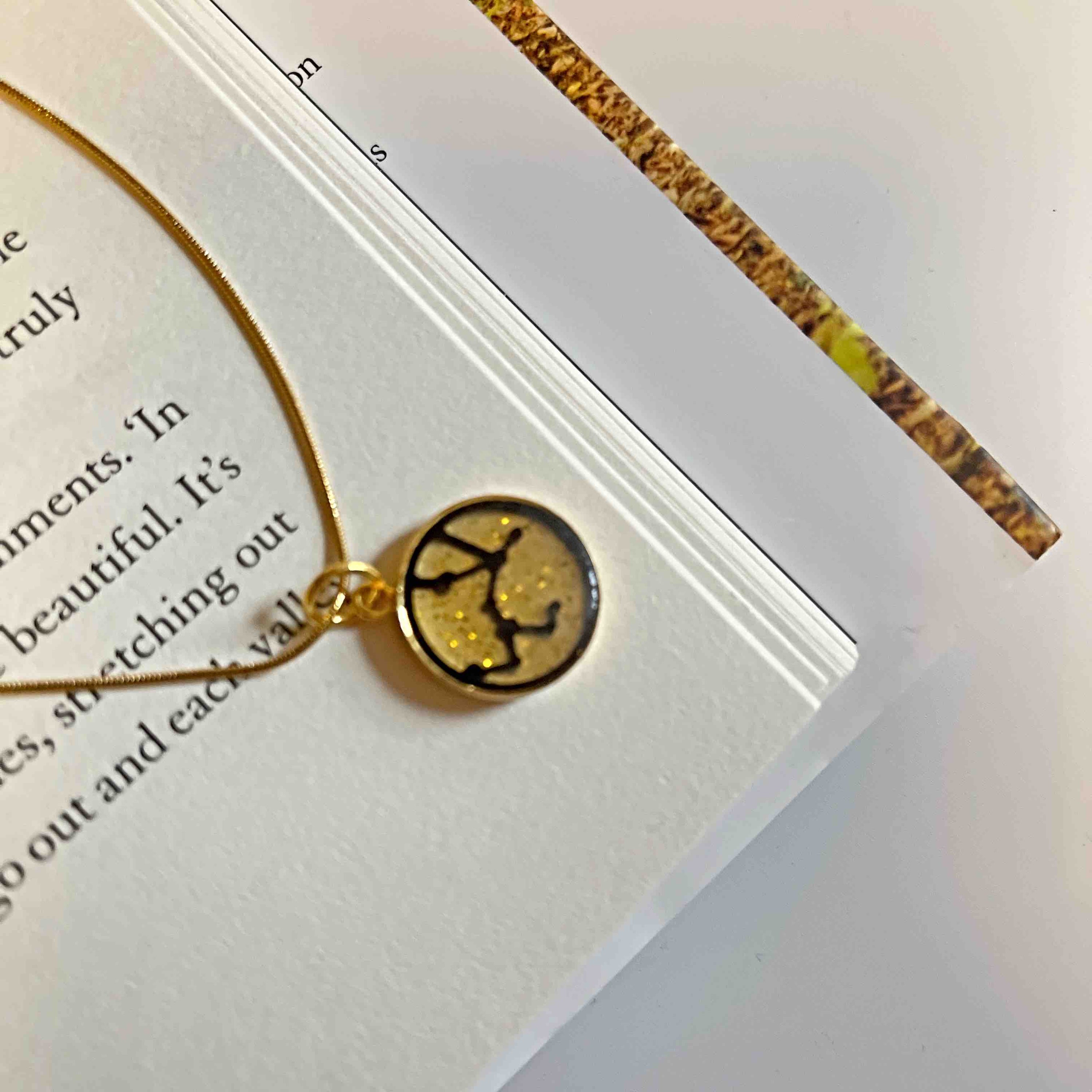 Sustainable Sagittarius Zodiac Sign Necklace made from recycled wood and plant resin, featuring a gold plated brass pendant and chain.