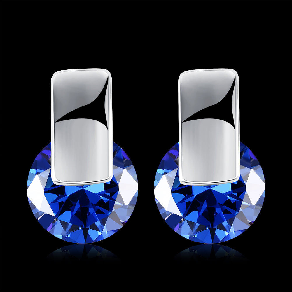 Elegant sapphire stud earrings set in 18K white gold plating, showcasing a rich blue color and a comfortable design.