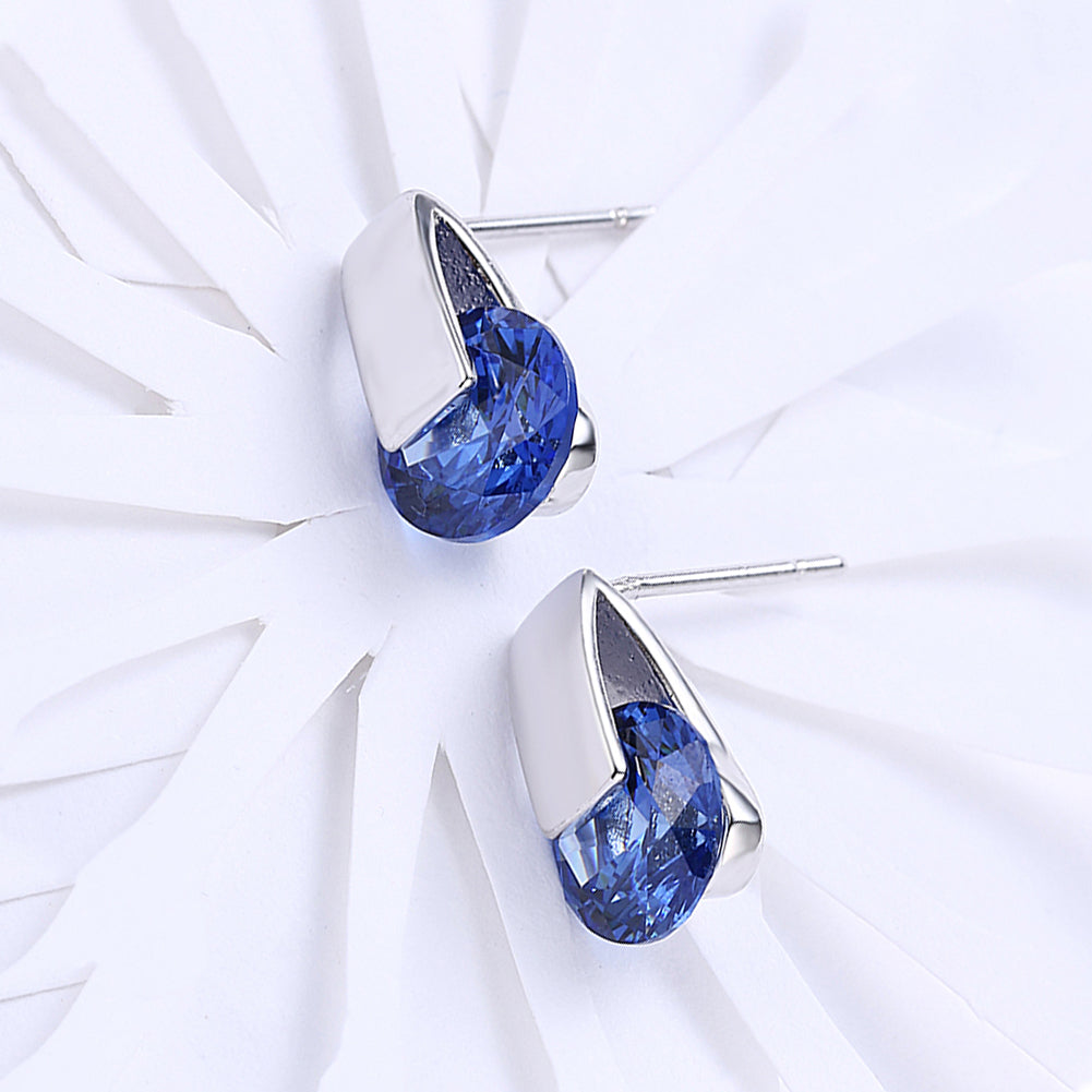 Elegant sapphire stud earrings set in 18K white gold plating, showcasing a rich blue color and a comfortable design.