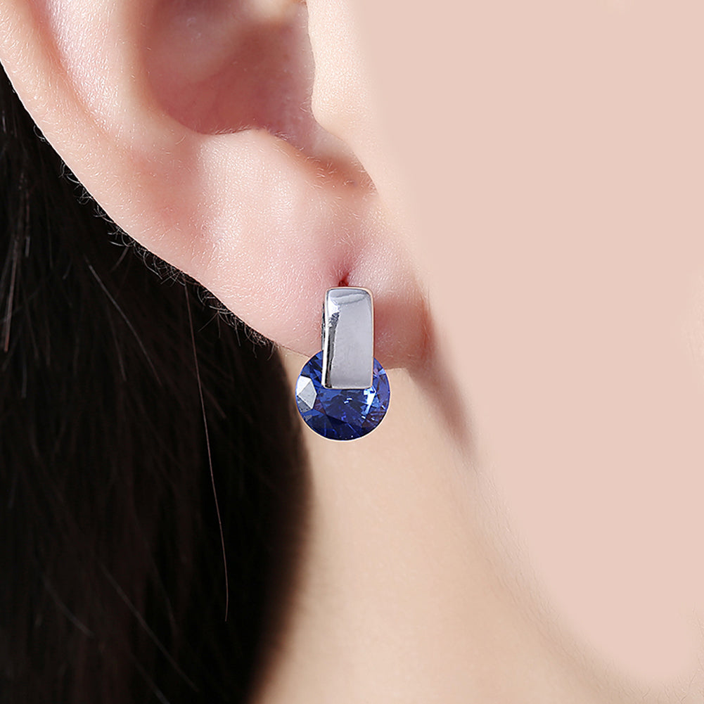 Elegant sapphire stud earrings set in 18K white gold plating, showcasing a rich blue color and a comfortable design.