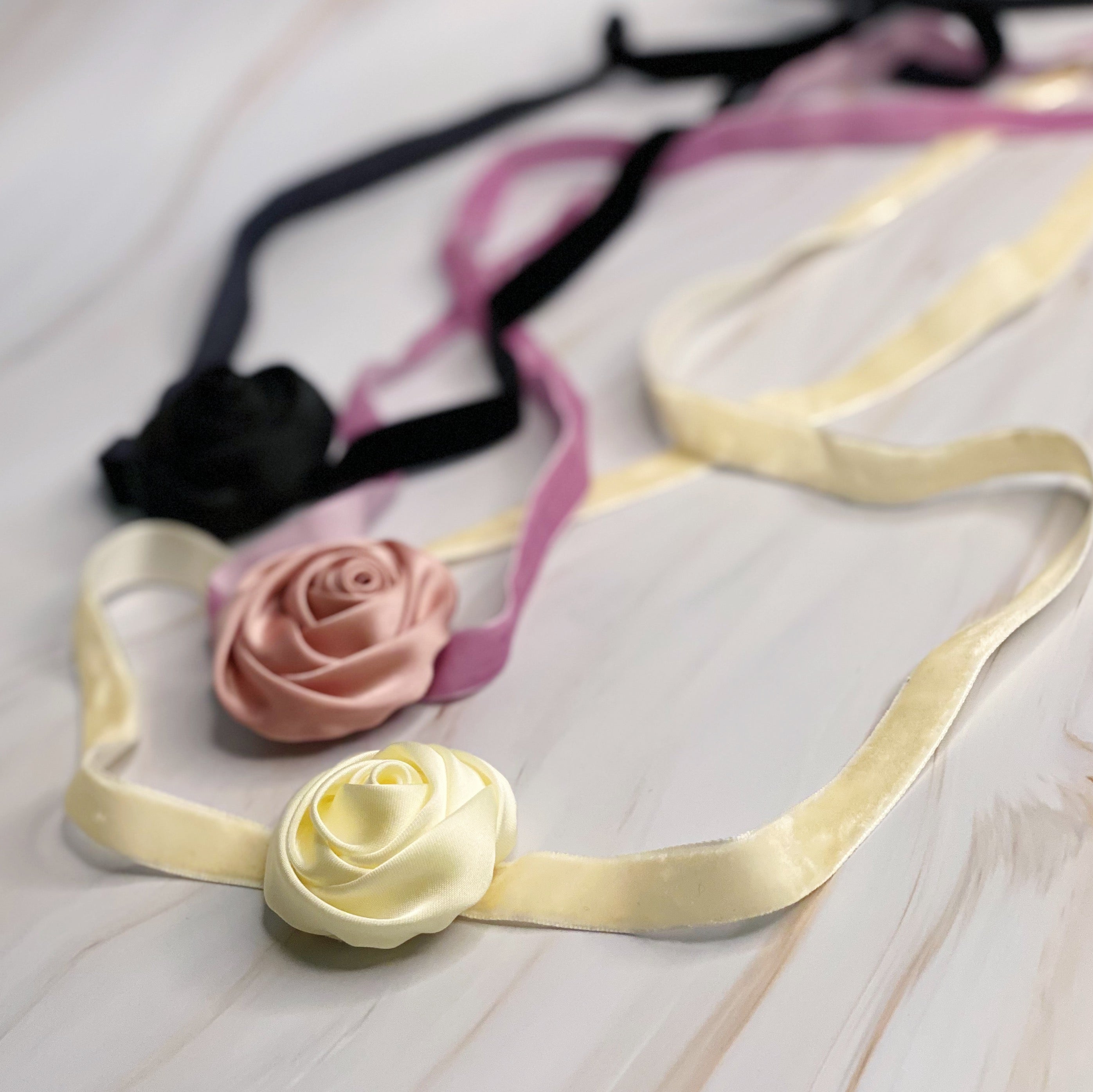 A beautifully crafted Satin Rose Velvet Sash Necklace with a soft velvet tie, showcasing its versatility as a choker, bracelet, or hair accessory.