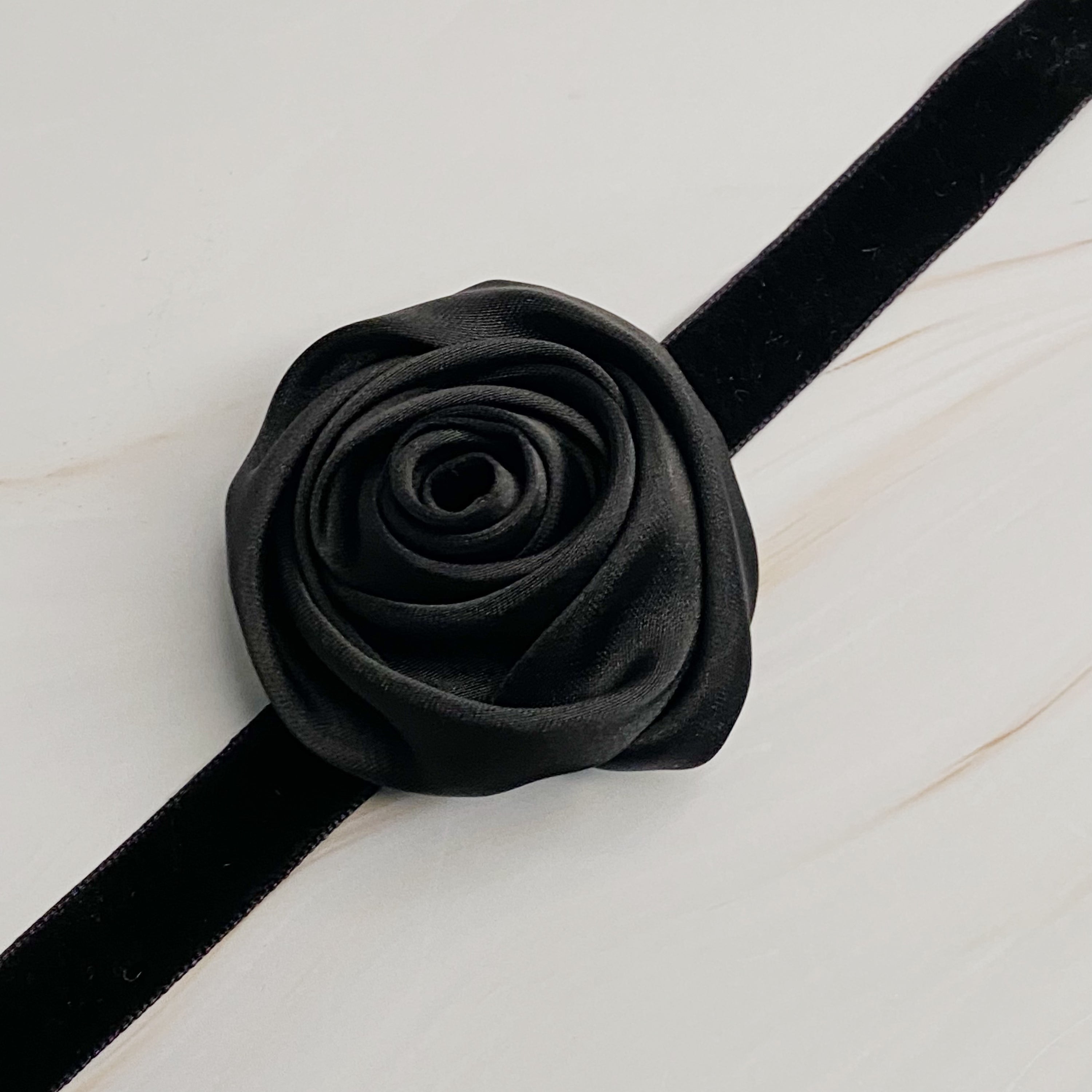 A beautifully crafted Satin Rose Velvet Sash Necklace with a soft velvet tie, showcasing its versatility as a choker, bracelet, or hair accessory.