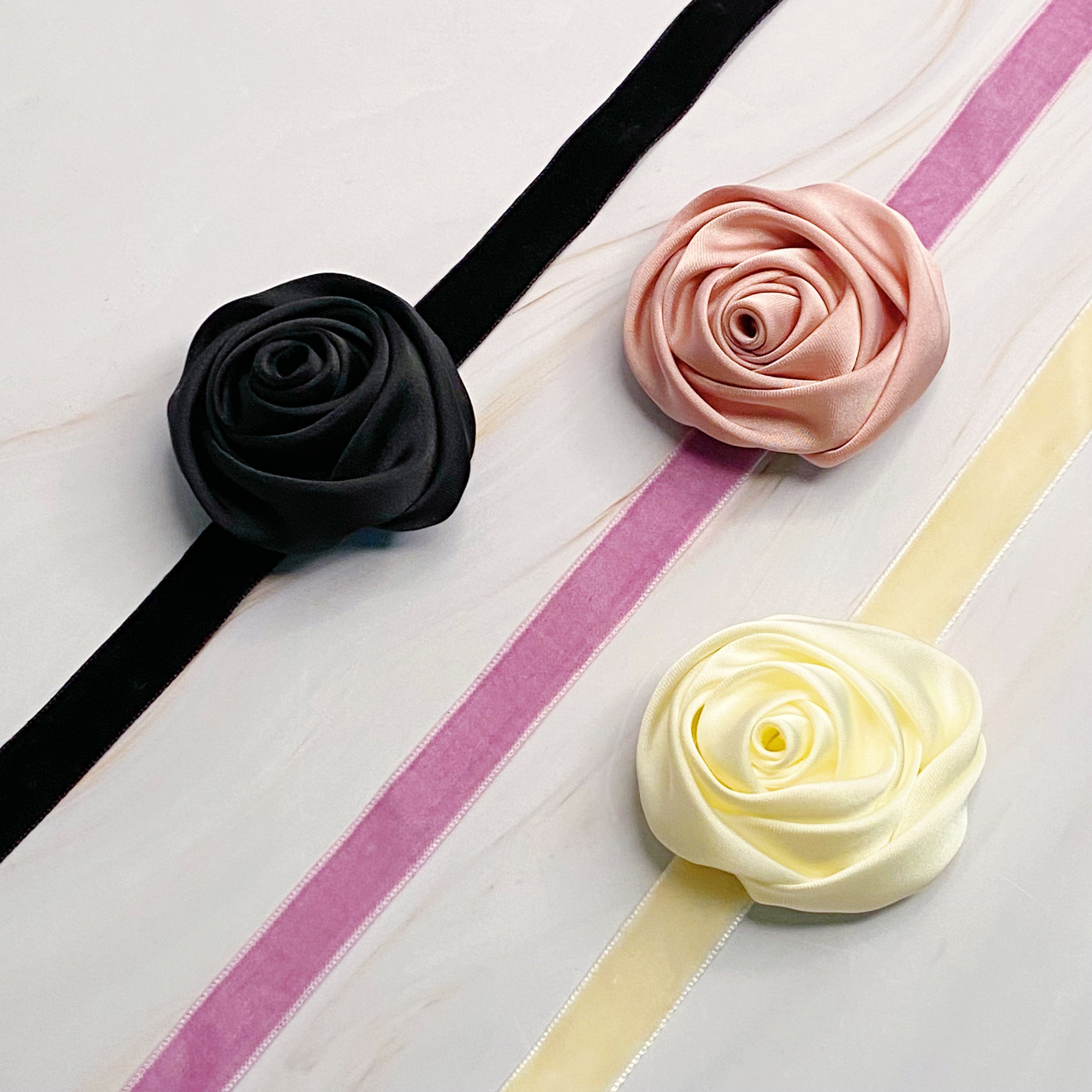 A beautifully crafted Satin Rose Velvet Sash Necklace with a soft velvet tie, showcasing its versatility as a choker, bracelet, or hair accessory.