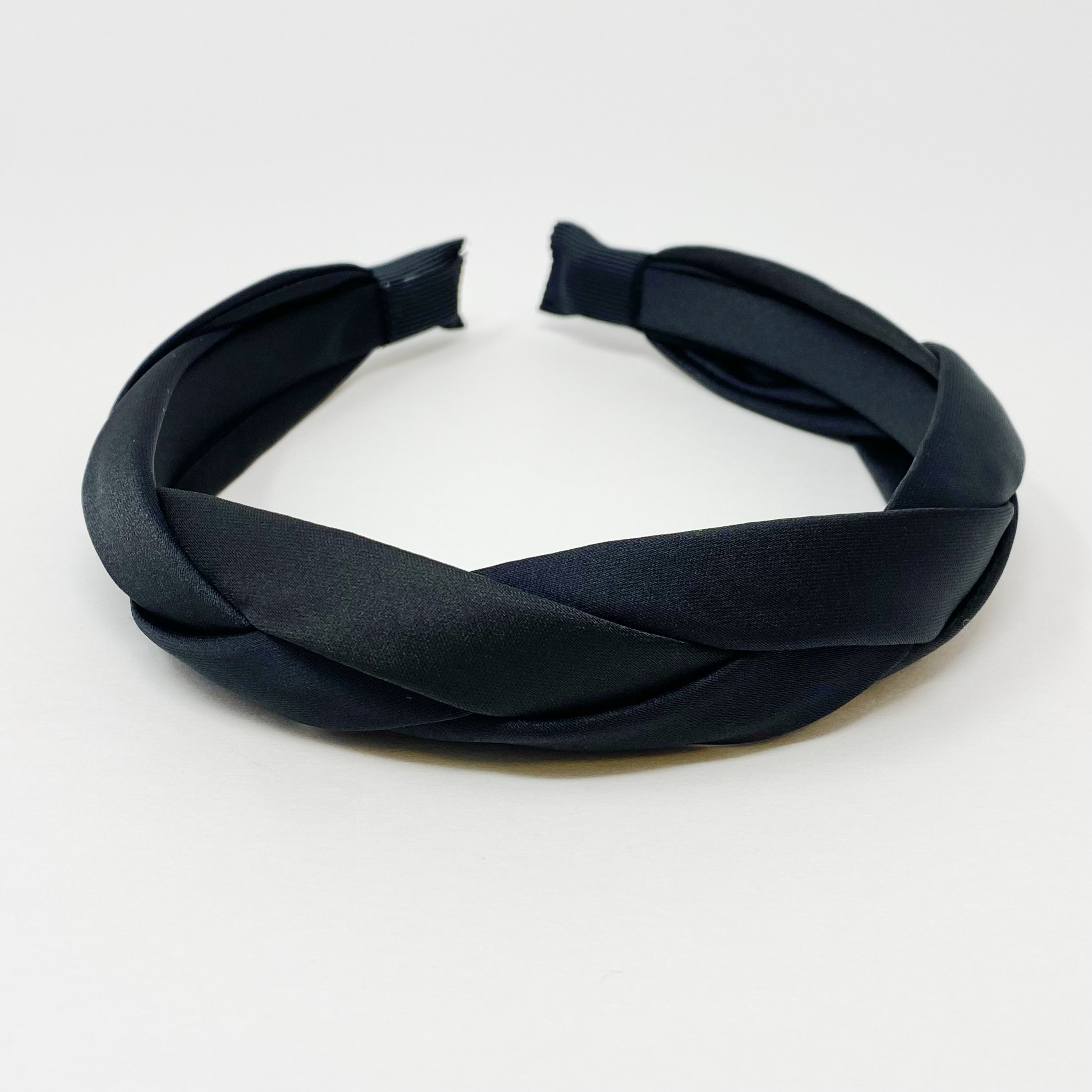 A luxurious satin silk braid headband featuring a twisted design, perfect for adding elegance to any hairstyle.