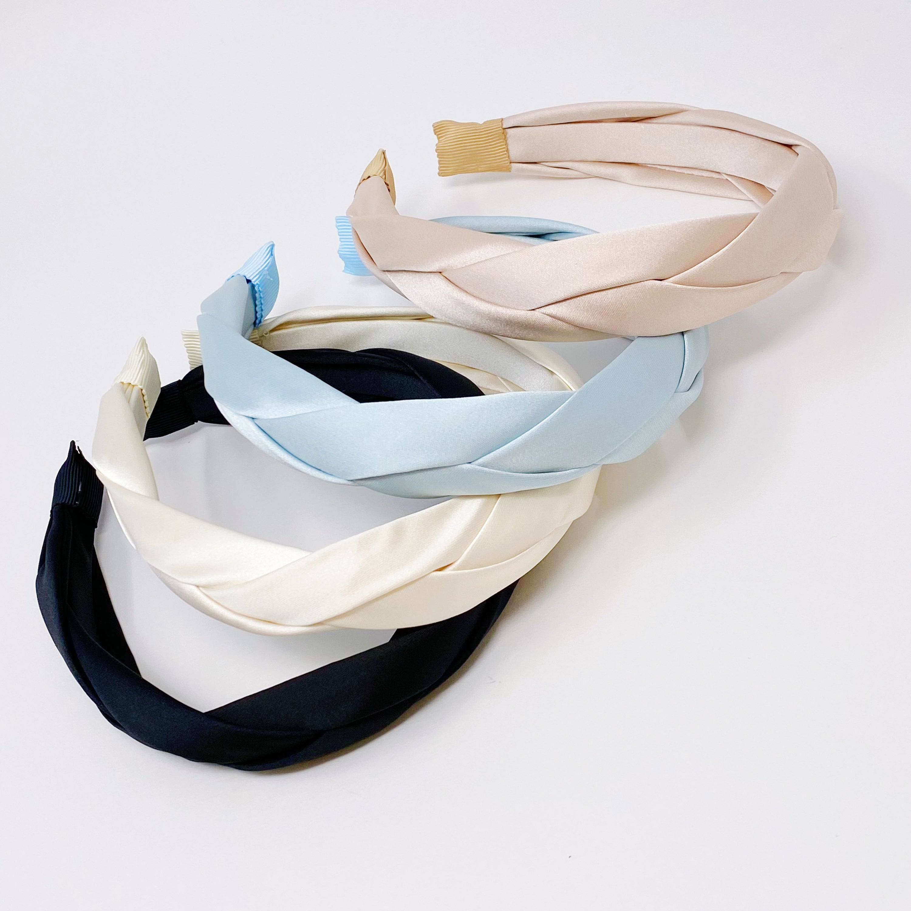 A luxurious satin silk braid headband featuring a twisted design, perfect for adding elegance to any hairstyle.