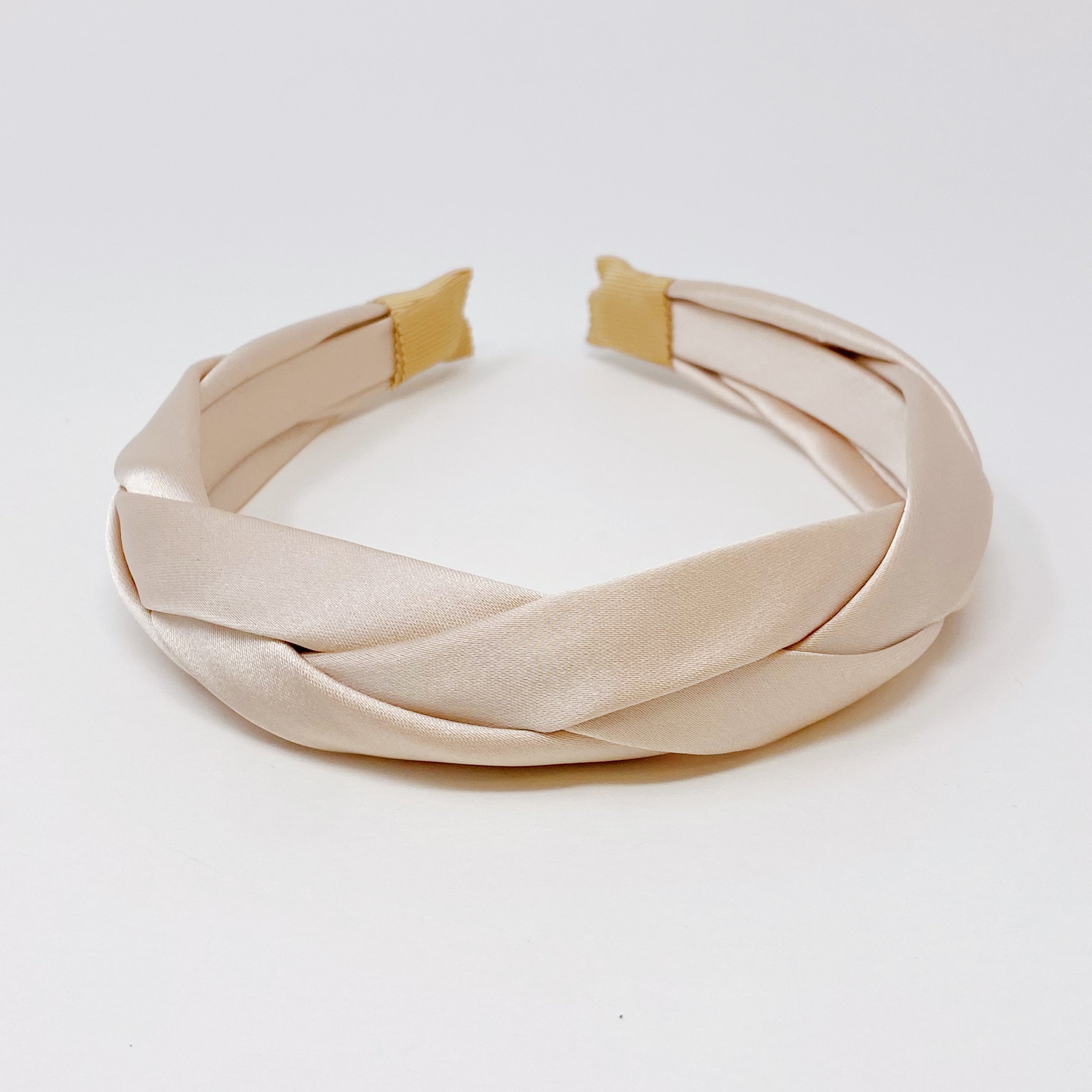 A luxurious satin silk braid headband featuring a twisted design, perfect for adding elegance to any hairstyle.