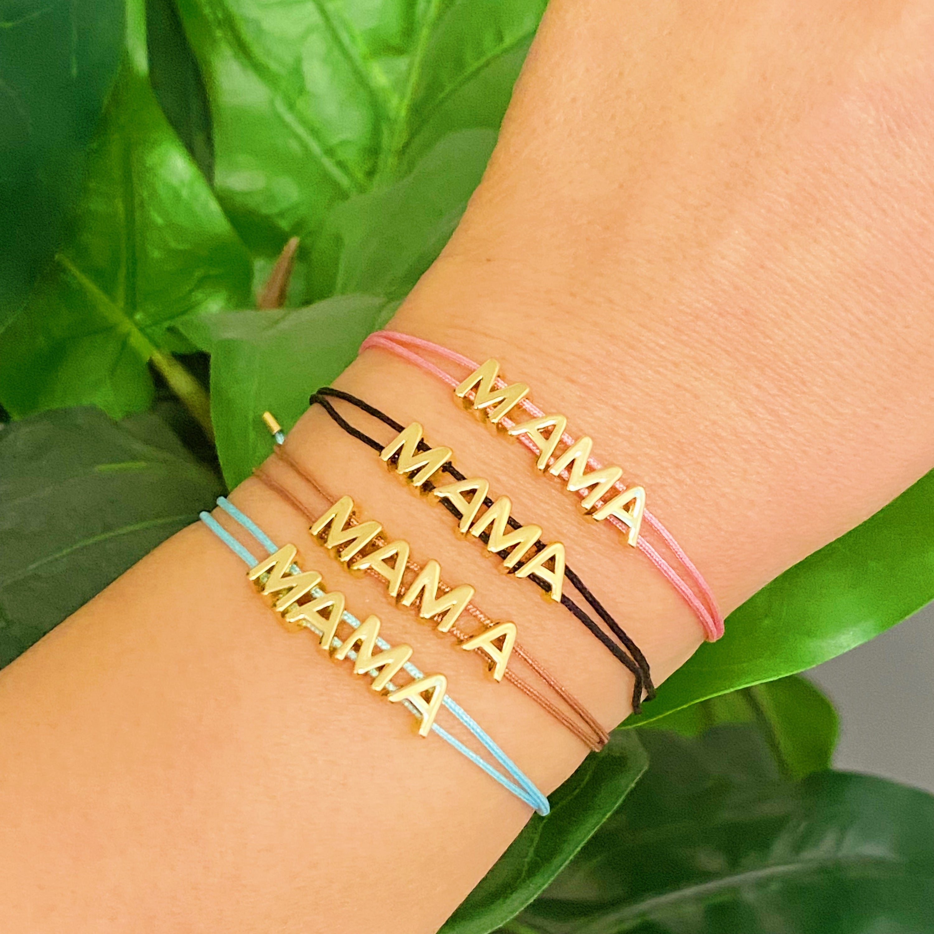 A stylish Satin Thread Mama Bracelet featuring a slim satin thread with golden 'MAMA' lettering, adjustable for a perfect fit.