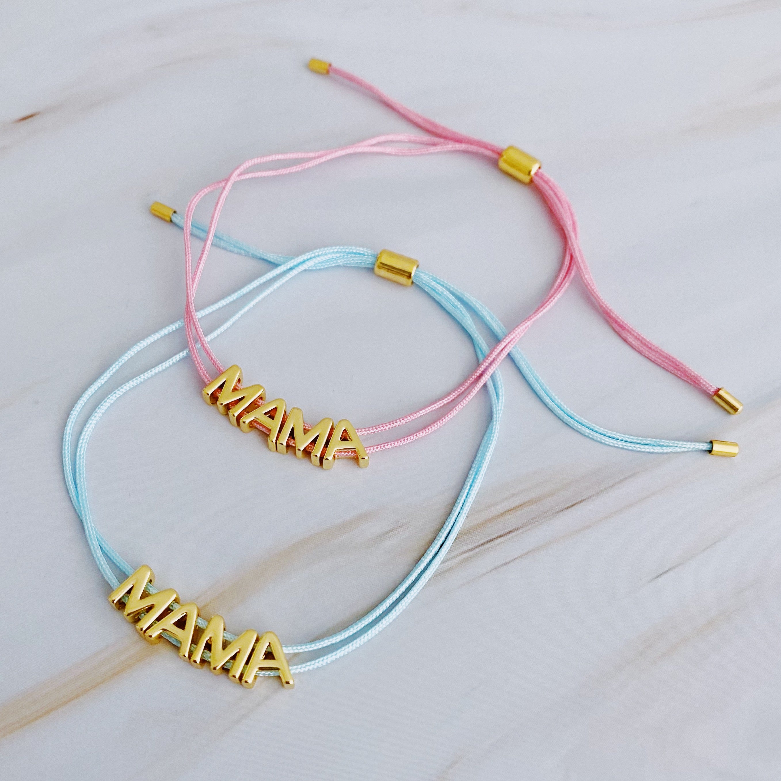 A stylish Satin Thread Mama Bracelet featuring a slim satin thread with golden 'MAMA' lettering, adjustable for a perfect fit.