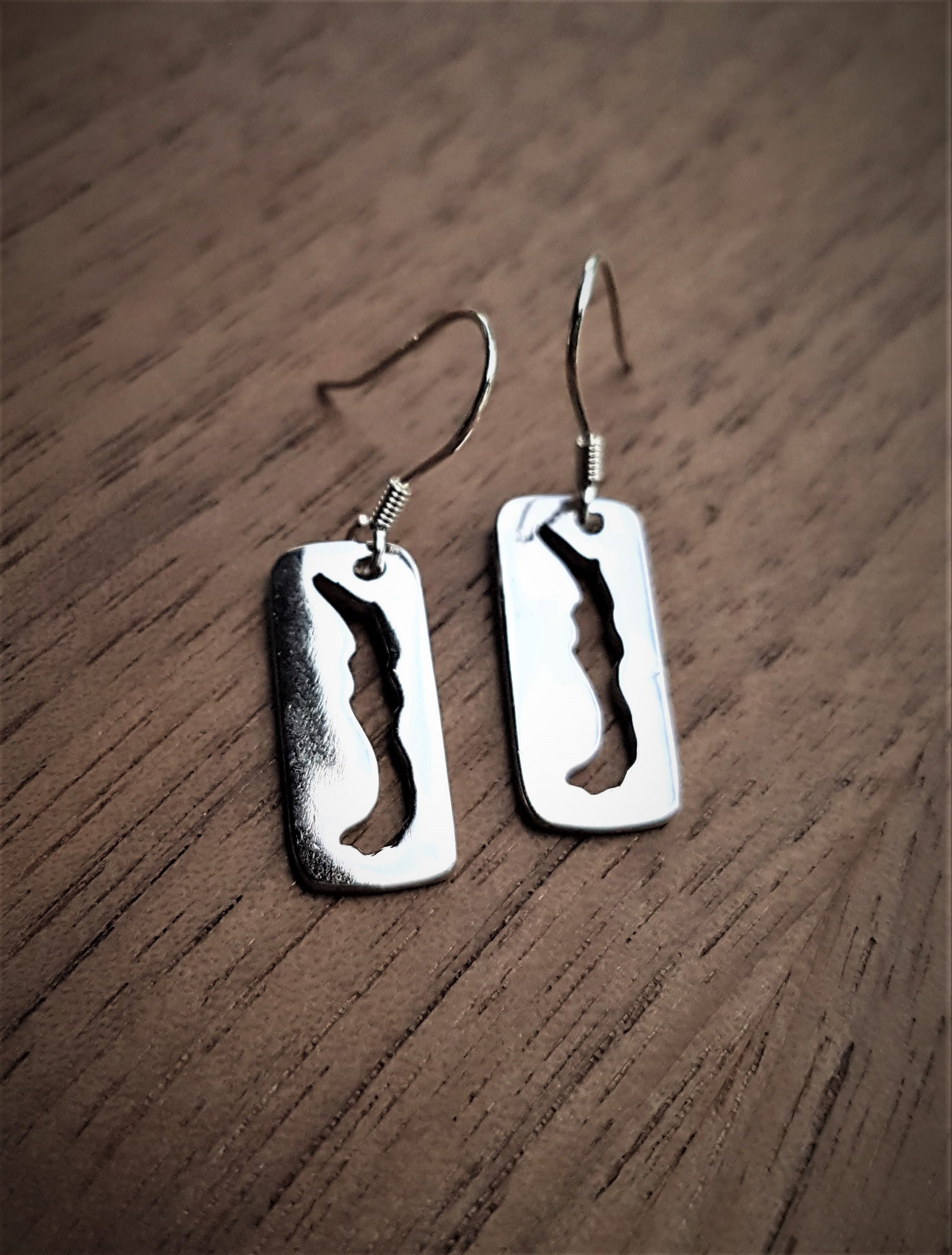 Savary Cut Out Earrings in sterling silver showcasing the silhouette of Savary Island, hung on elegant french ear wires.