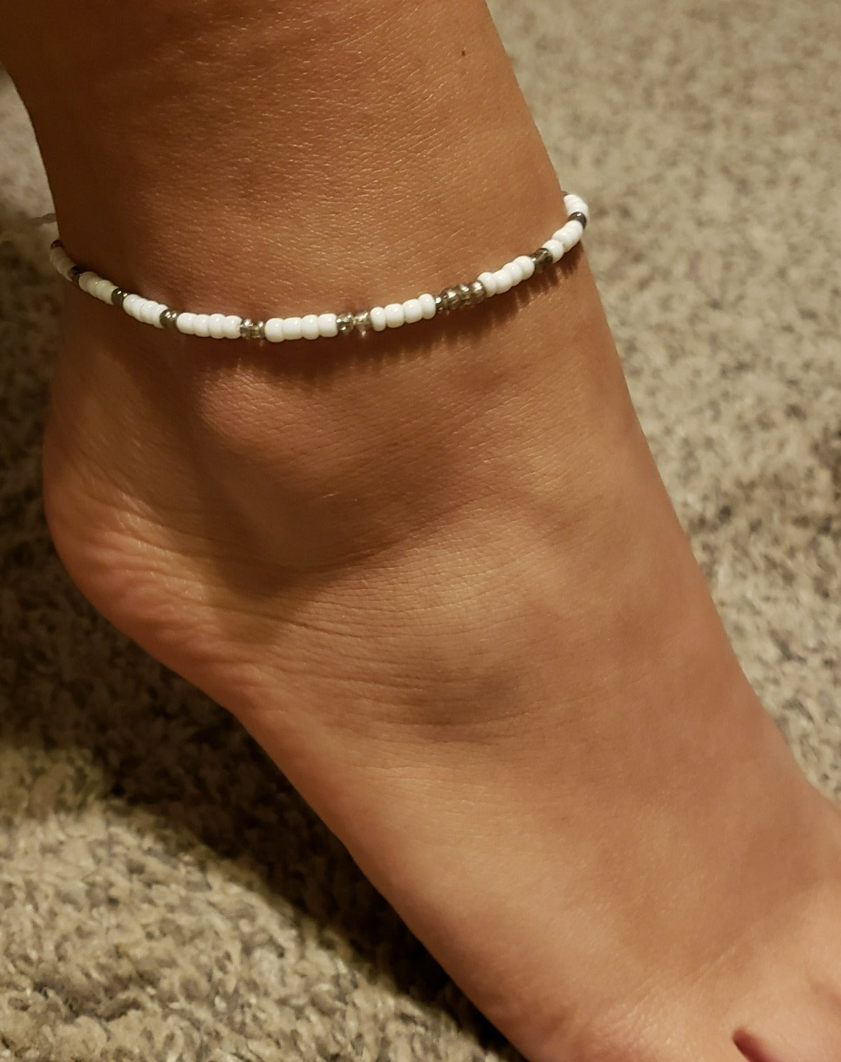 Savaya Anklet Ankle Bracelet featuring delicate white seed beads and a tiny seashell centerpiece, handmade in Bali.