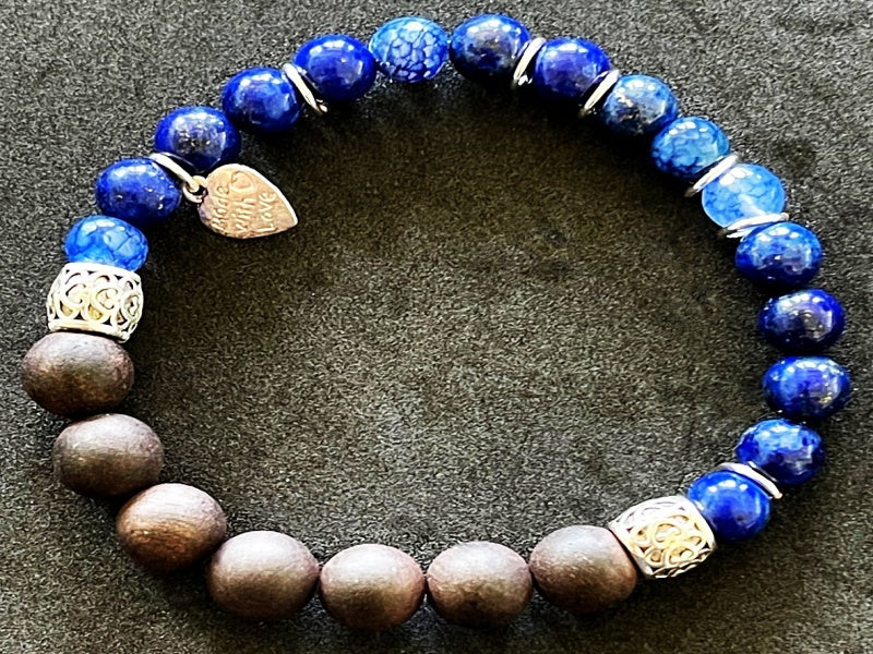 A stylish stretch bracelet featuring Morse Code spelling 'Breathe!' with green Aventurine, sesame jasper, and blue lapis lazuli gemstones.