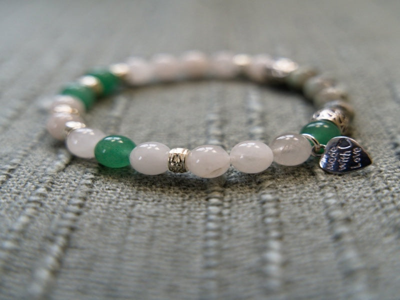 A stylish stretch bracelet featuring Morse Code spelling 'Breathe!' with green Aventurine, sesame jasper, and blue lapis lazuli gemstones.