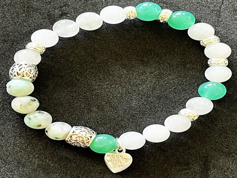 A stylish stretch bracelet featuring Morse Code spelling 'Breathe!' with green Aventurine, sesame jasper, and blue lapis lazuli gemstones.