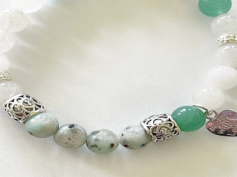 A stylish stretch bracelet featuring Morse Code spelling 'Breathe!' with green Aventurine, sesame jasper, and blue lapis lazuli gemstones.