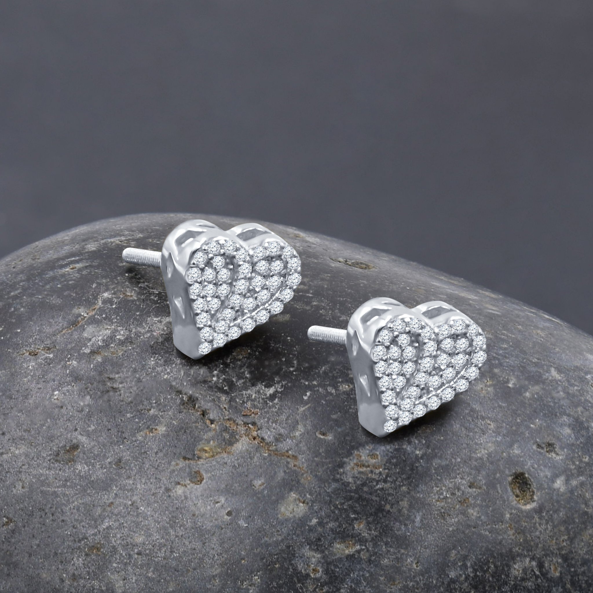 A pair of Scandalous Screw Back Earrings featuring heart-shaped designs with sparkling cubic zircon stones and golden plating.