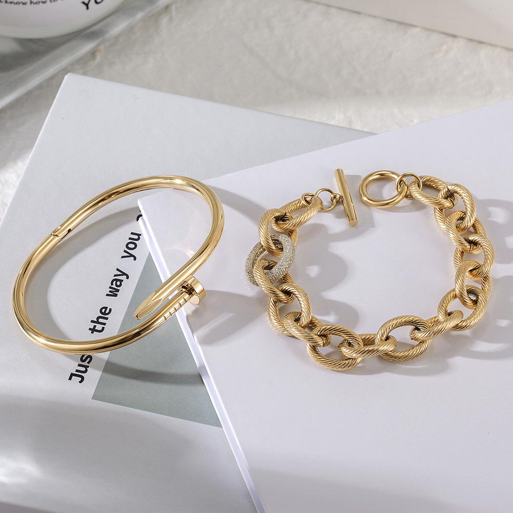 Screw Nail Wire Link Set featuring a gold and rose gold bangle and bracelet with cubic zirconia accents, elegantly displayed in a gift box.