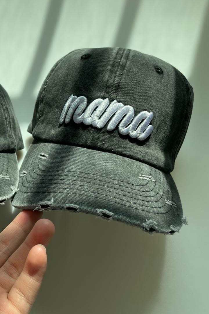 Dark gray distressed baseball cap with white 'Mama' embroidery and adjustable strap.