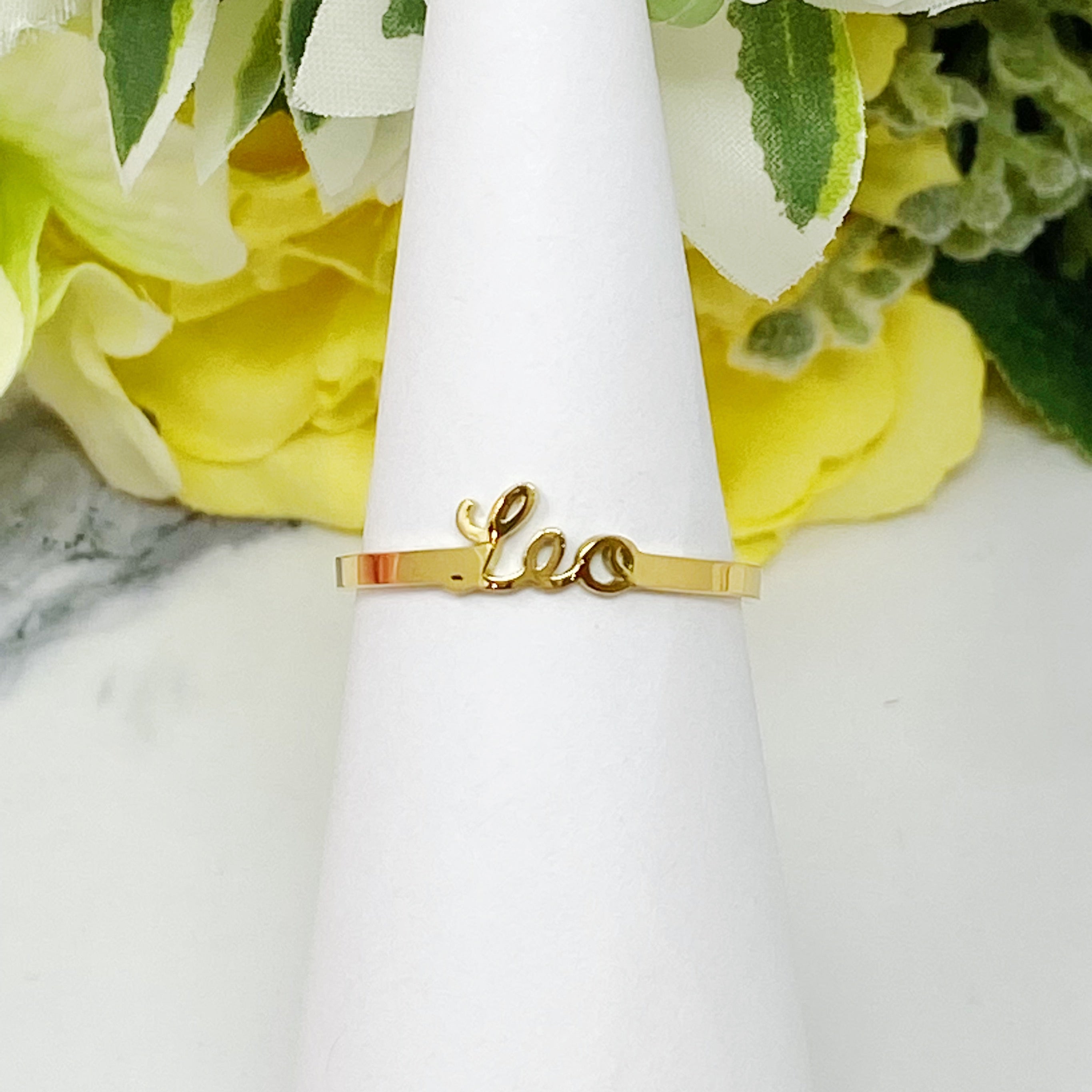 A beautifully crafted adjustable ring featuring delicately scripted zodiac signs, made of stainless steel and 18K gold plated.