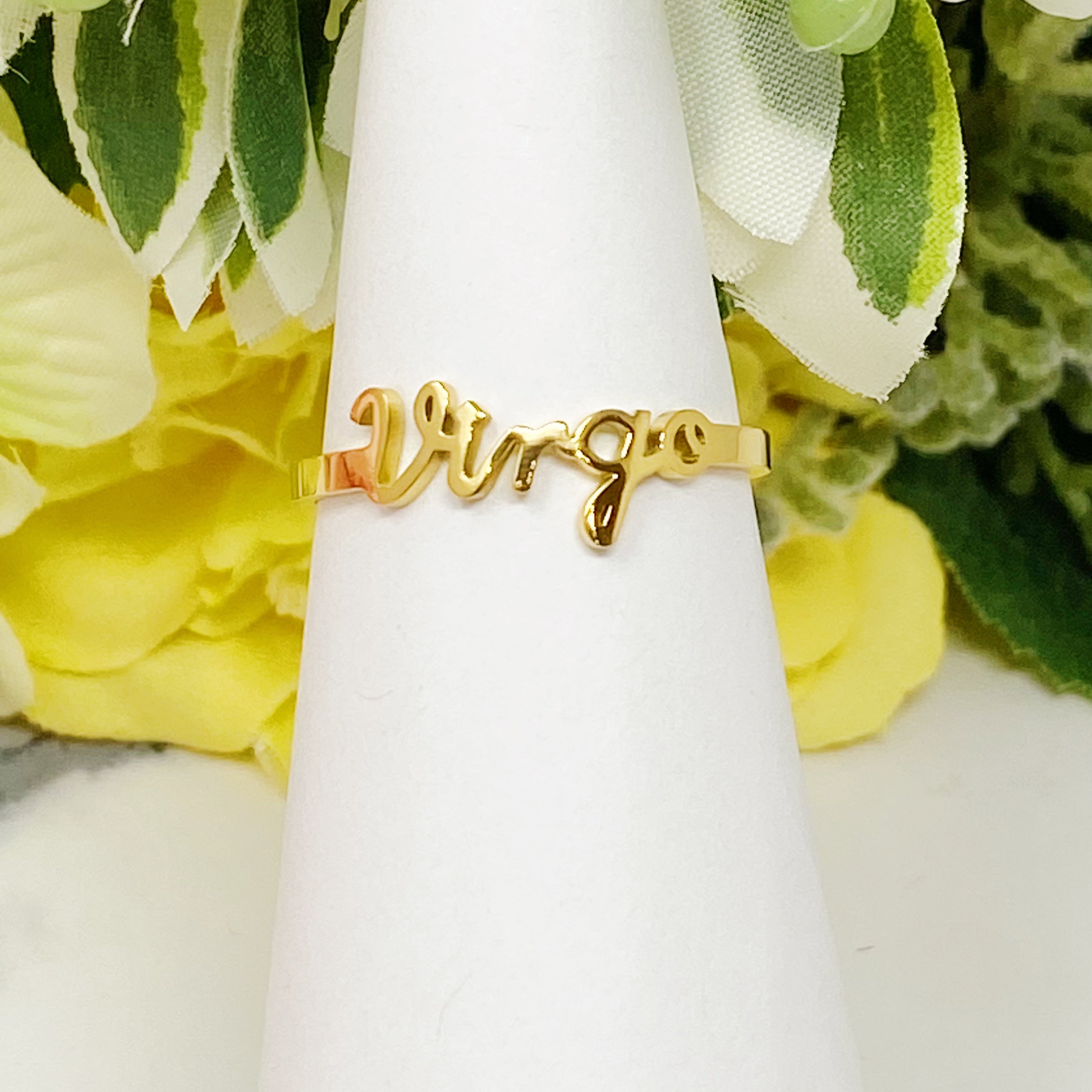 A beautifully crafted adjustable ring featuring delicately scripted zodiac signs, made of stainless steel and 18K gold plated.