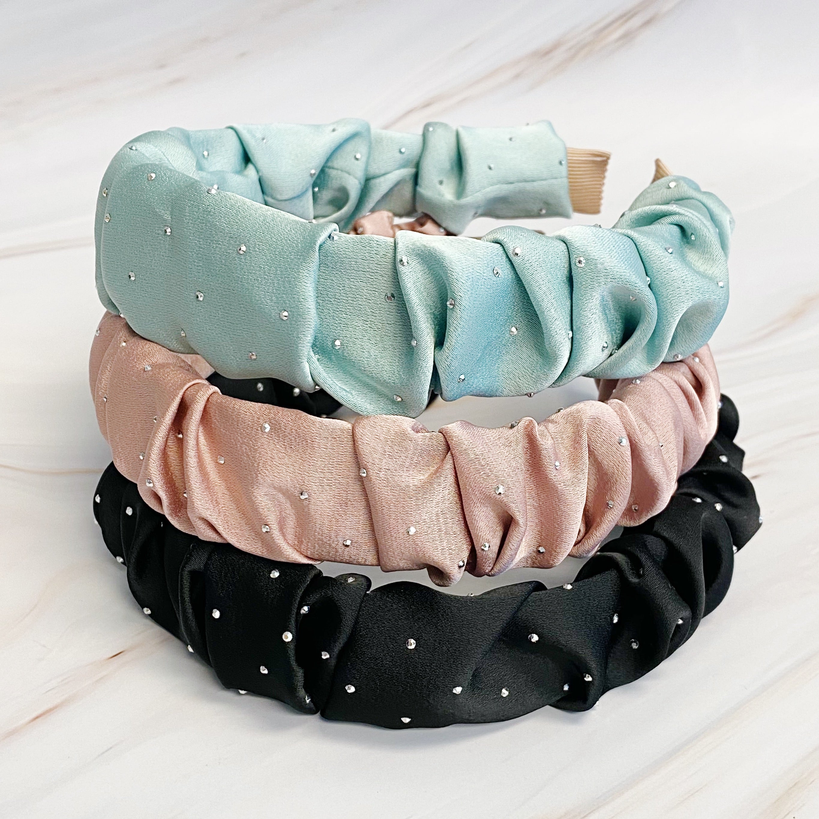 Scrunched Satin Jewel Dotted Headband featuring elegant satin fabric with sparkly jewel dots, perfect for stylish outfits.