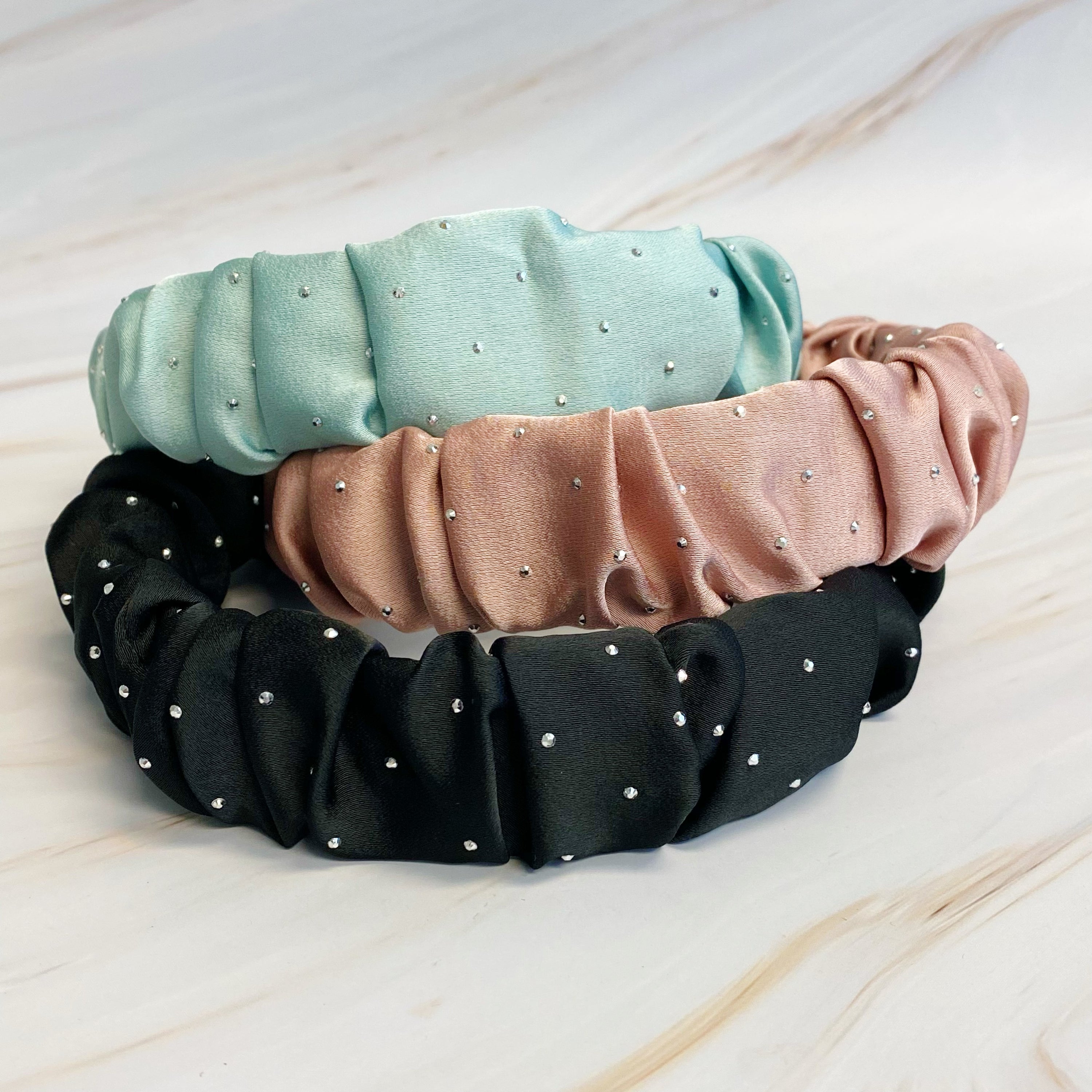 Scrunched Satin Jewel Dotted Headband featuring elegant satin fabric with sparkly jewel dots, perfect for stylish outfits.