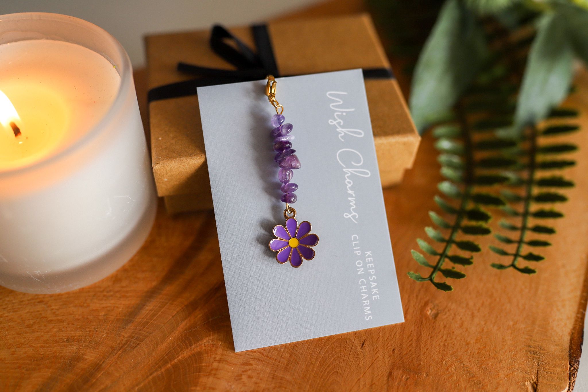 A beautiful Sea Shell Wish Charm featuring glass beads and Tibetan silver, elegantly displayed on a glossy card.