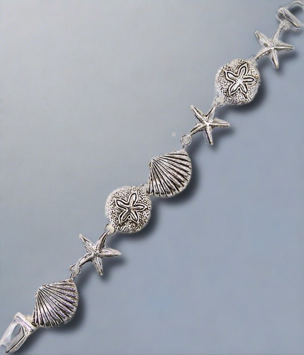 A beautiful silver seashell charm bracelet with seven detailed seashells and a magnetic closure, perfect for beach lovers.