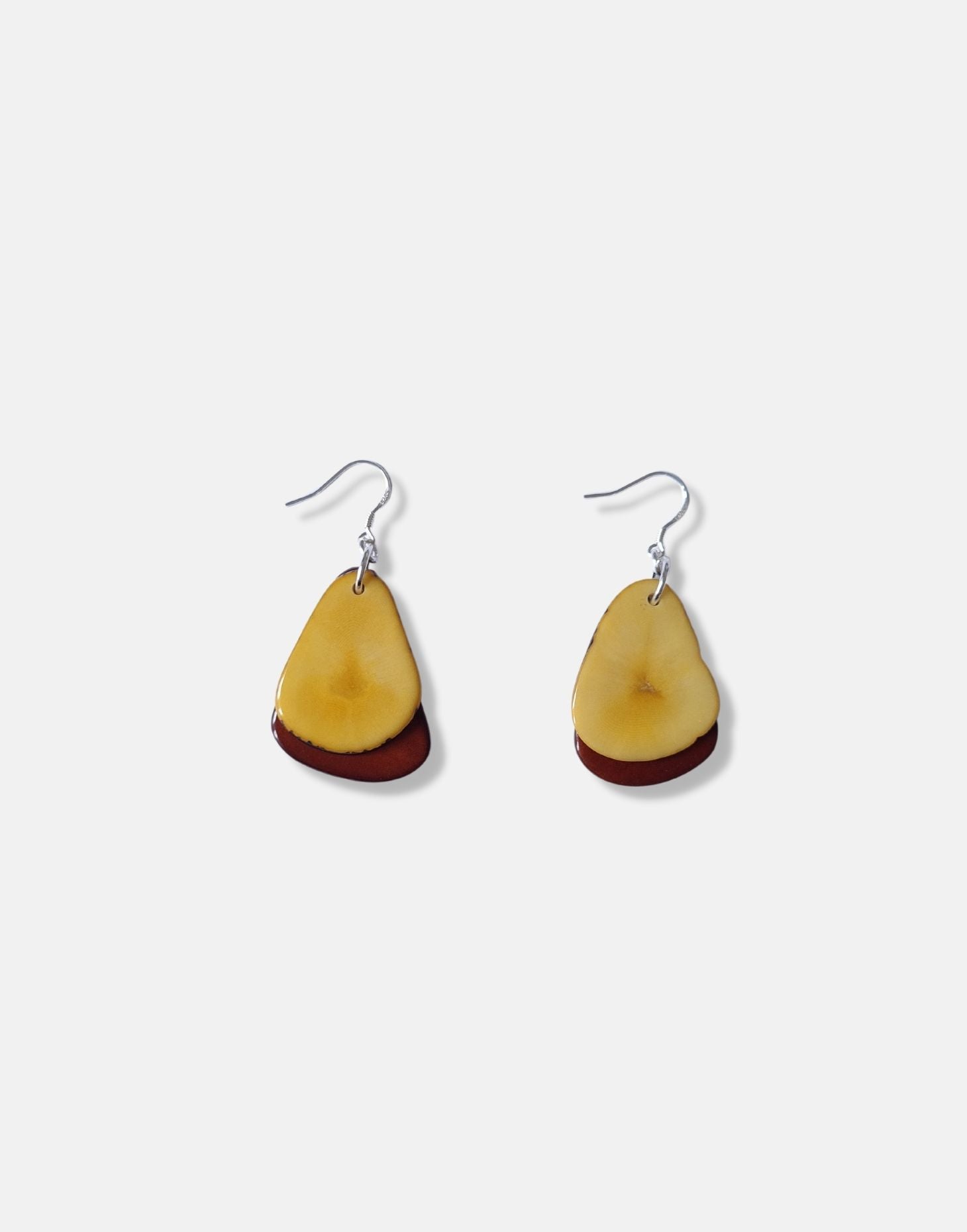 A pair of Secca Tagua Nut Earrings featuring organic vegetable ivory slices and sterling silver hooks, elegantly displayed in eco-friendly packaging.