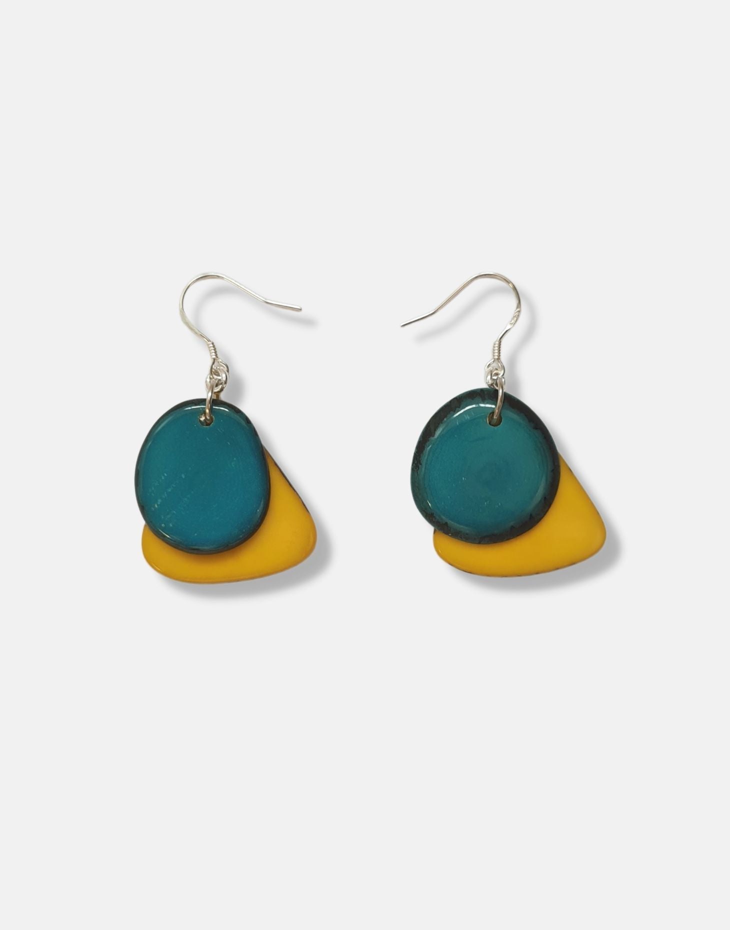 A pair of Secca Tagua Nut Earrings featuring organic vegetable ivory slices and sterling silver hooks, elegantly displayed in eco-friendly packaging.