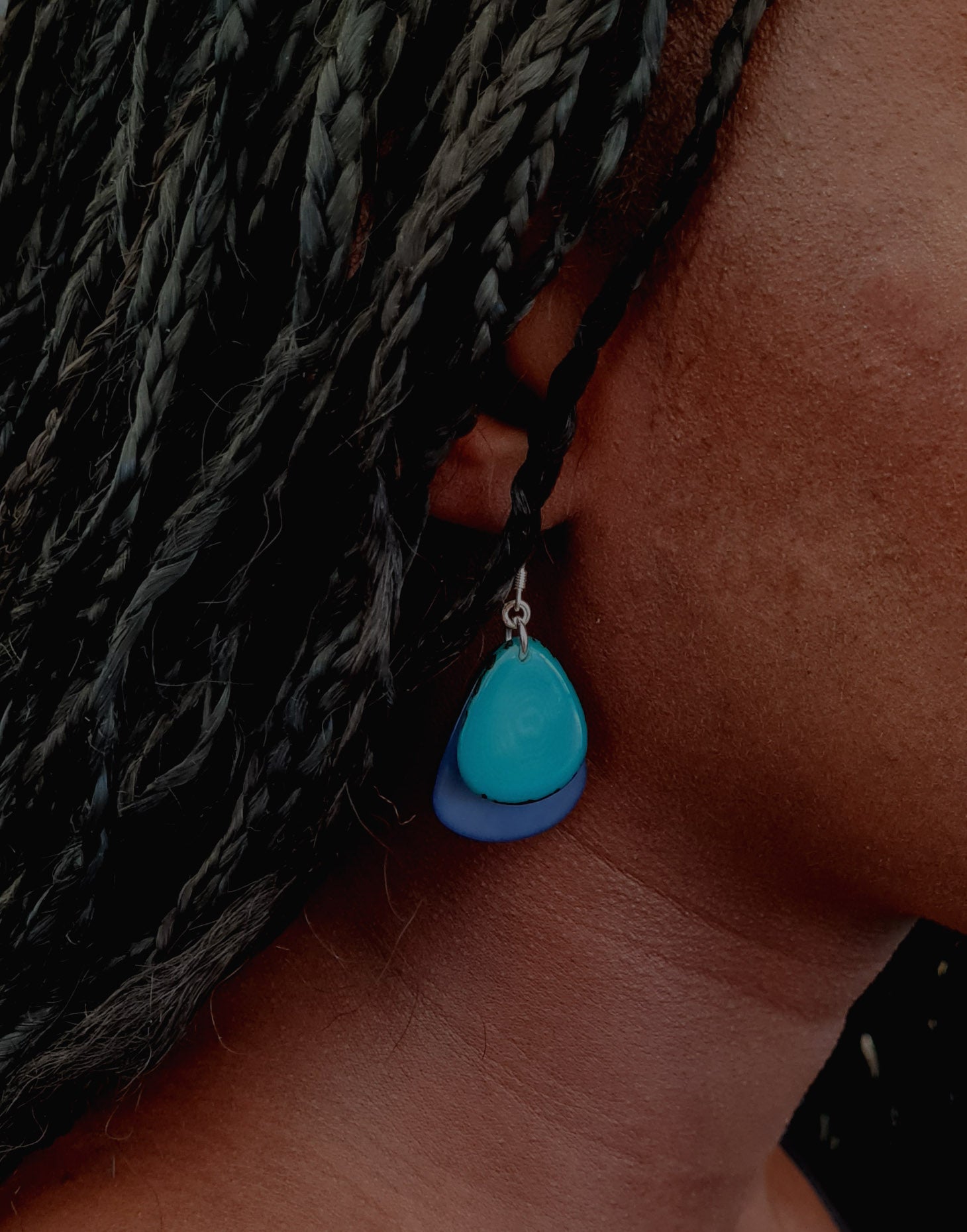 A pair of Secca Tagua Nut Earrings featuring organic vegetable ivory slices and sterling silver hooks, elegantly displayed in eco-friendly packaging.